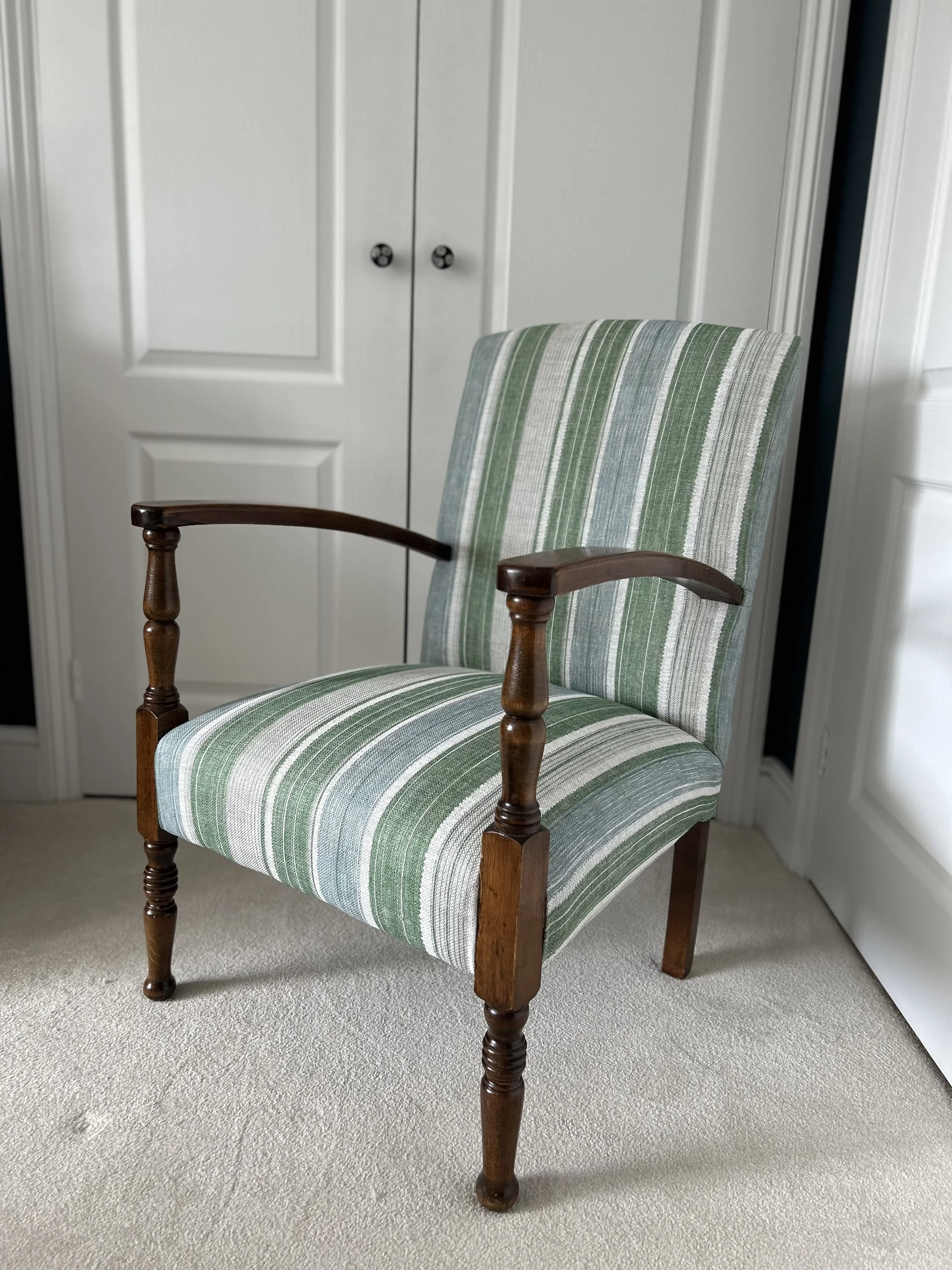 Antique open-arm chair reupholstered in a green and blue stripe by Fermoie
