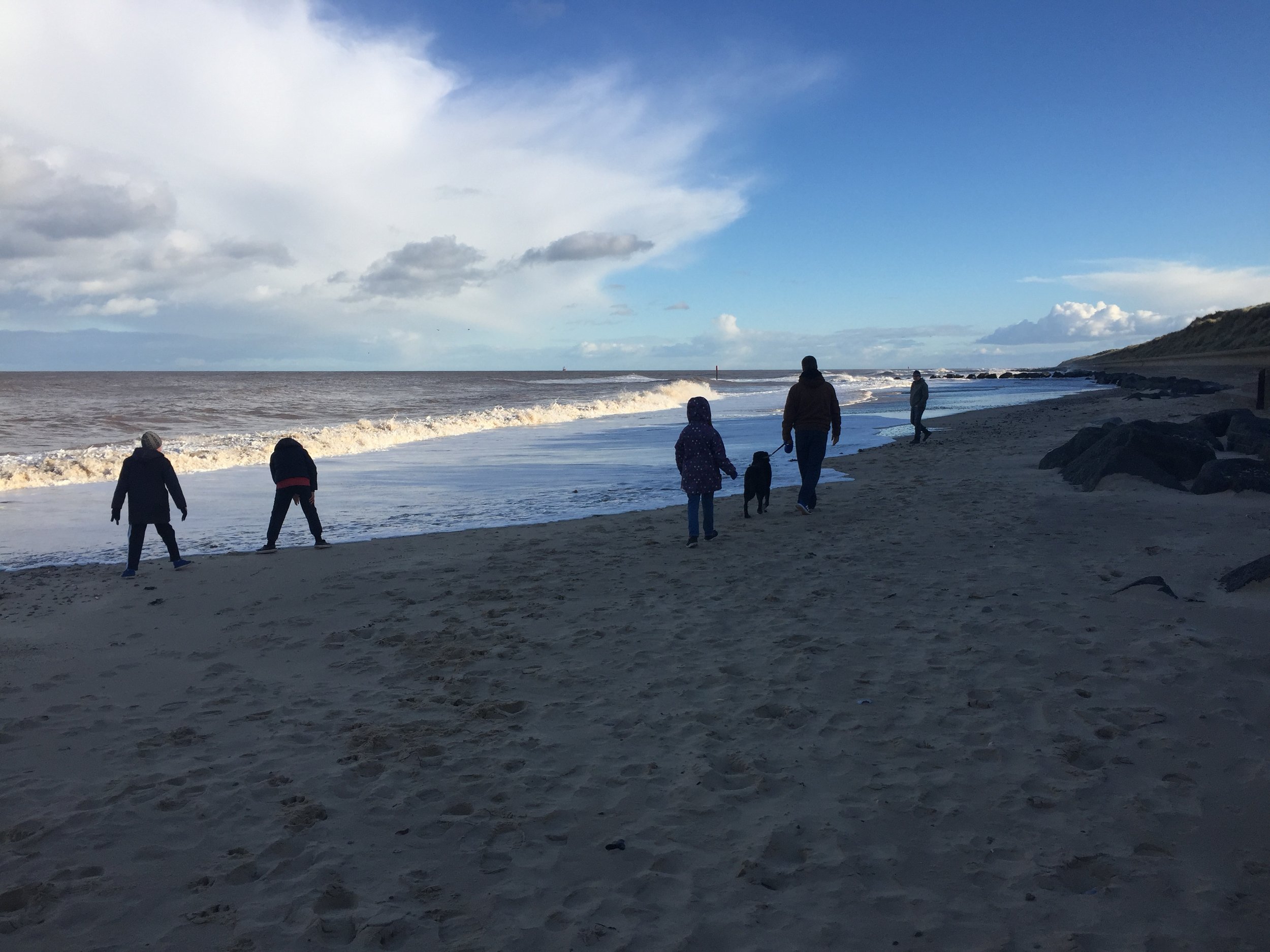 Family on a beach dog walk near Shangri-la House Waxham