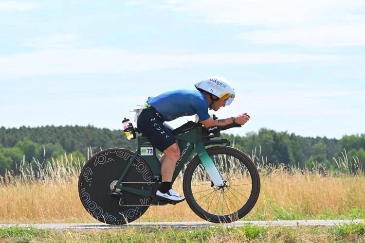 Man riding a bike in a triathlon compettion.
