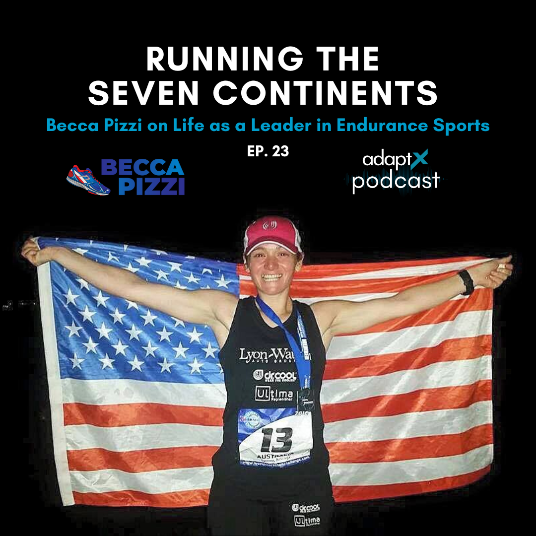 A female athlete holding an American flag behind her with arms outstretched, smiling, and wearing running gear and a pink cap.