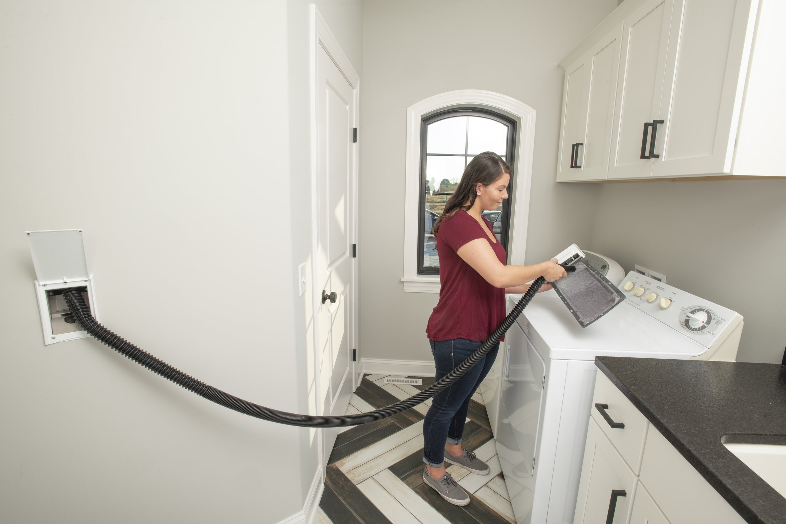Chameleon retractable hose valve installed in a finished laundry room