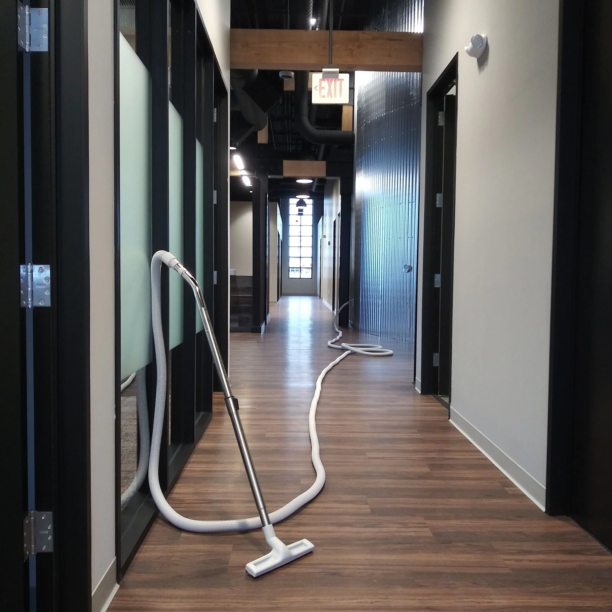 Built-in vacuum hose in a commercial corridor