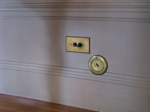 Historic brass central vacuum inlet