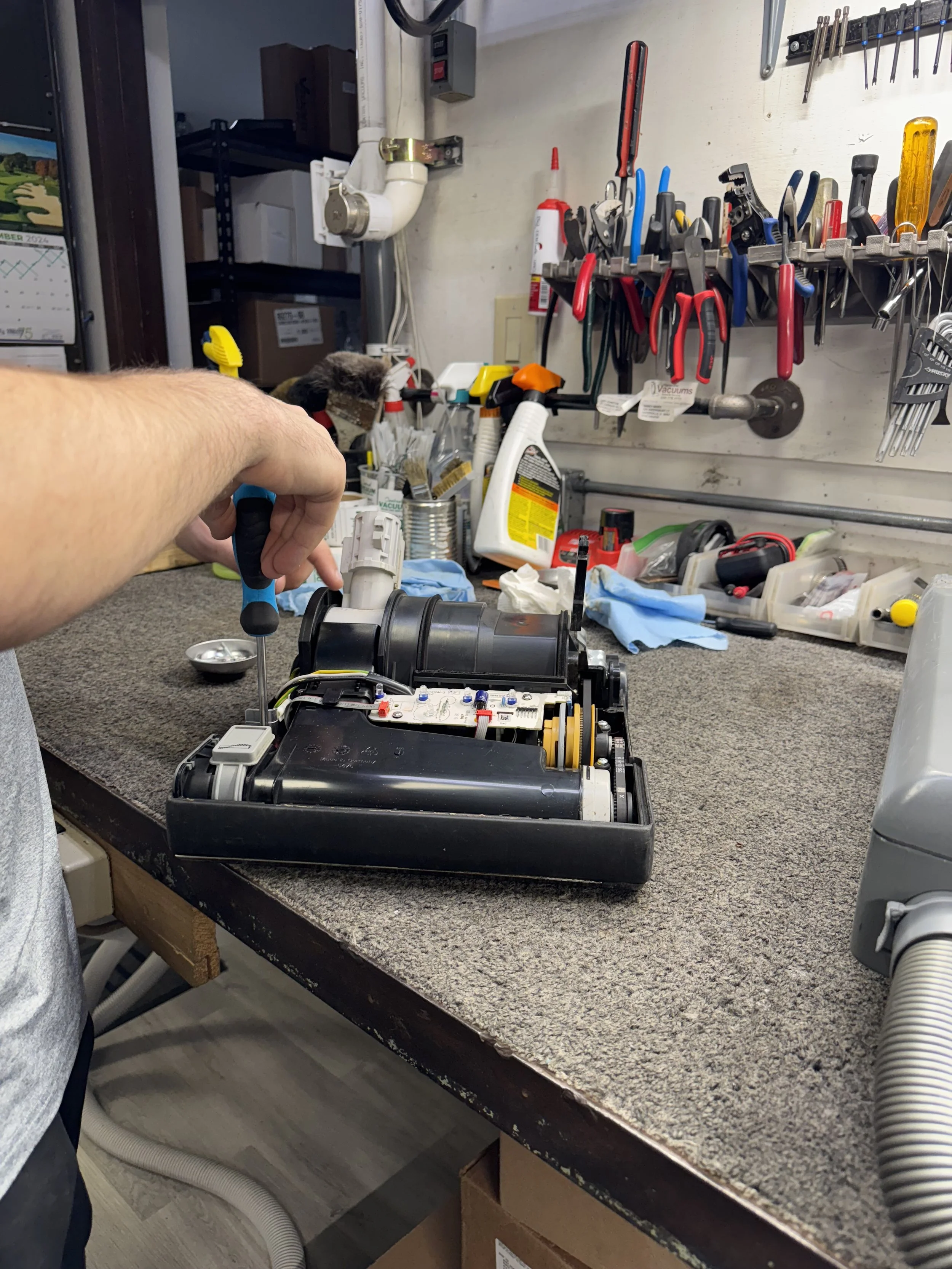 Vacuum cleaner disassembled for diagnosis on the Central Vacuum repair bench