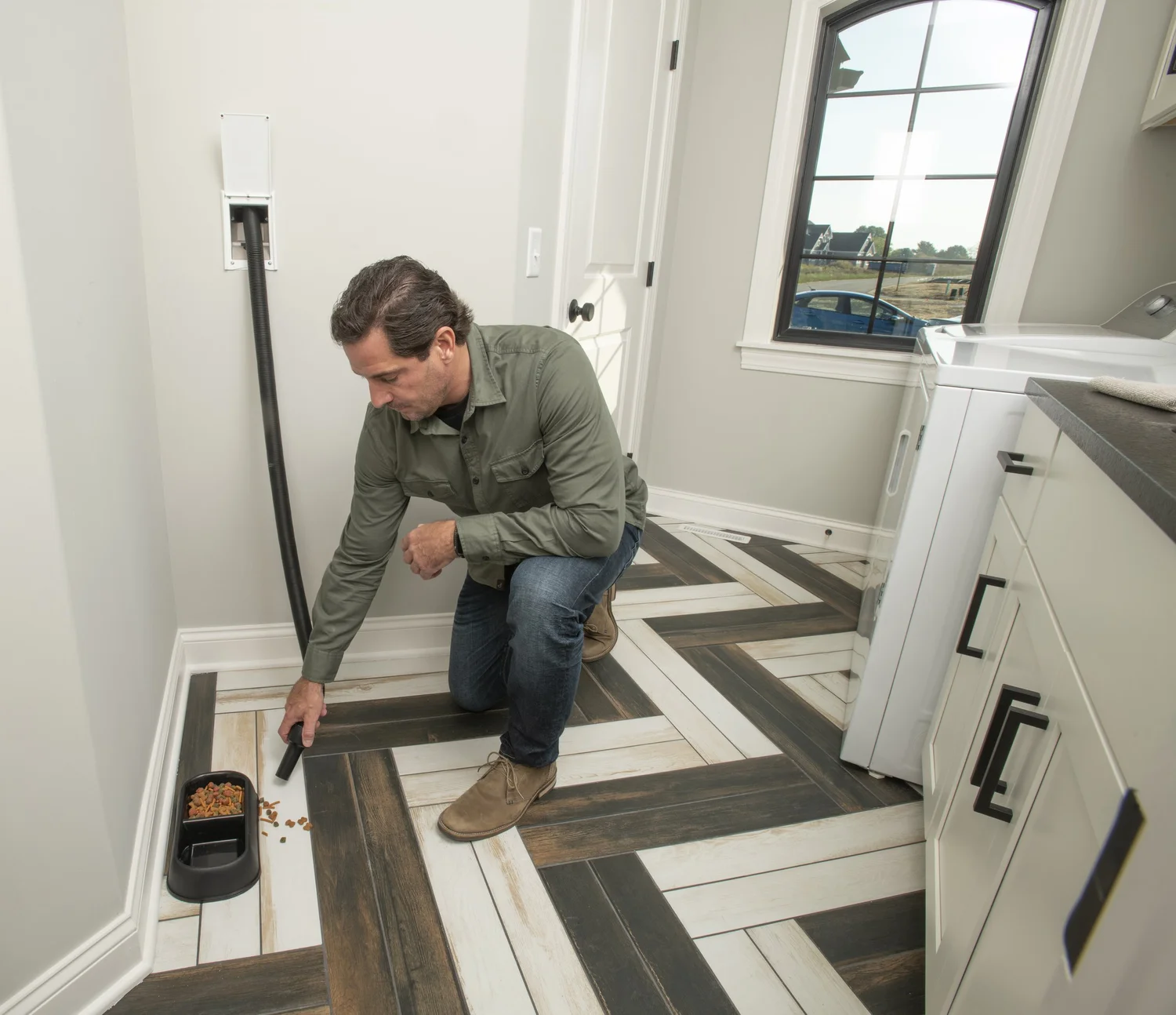 Cleaning spilled pet food with retractable central vacuum hose