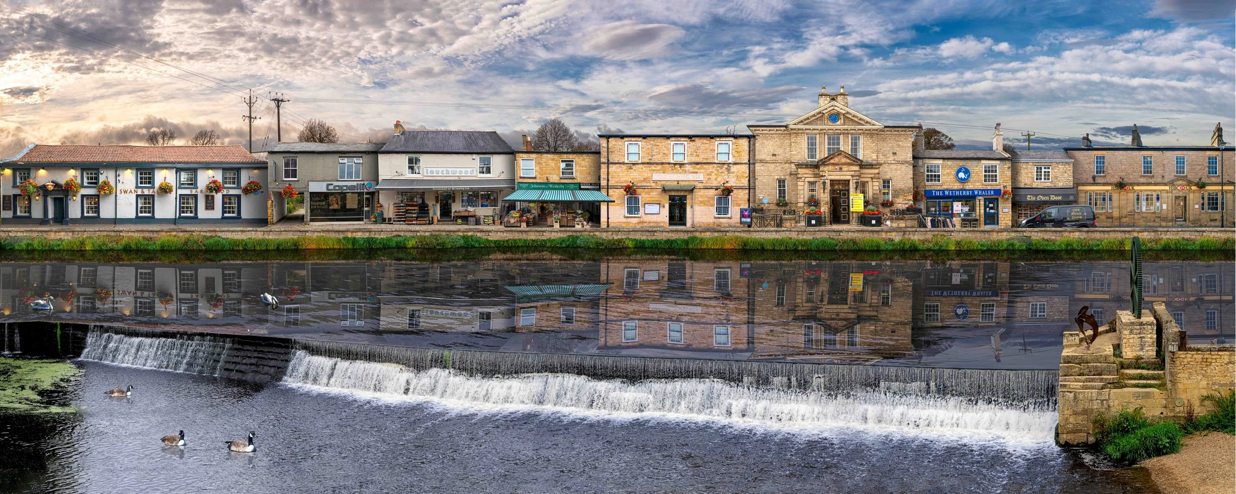 Wetherby Yorkshire town artwork showing buildings between morning and evening
