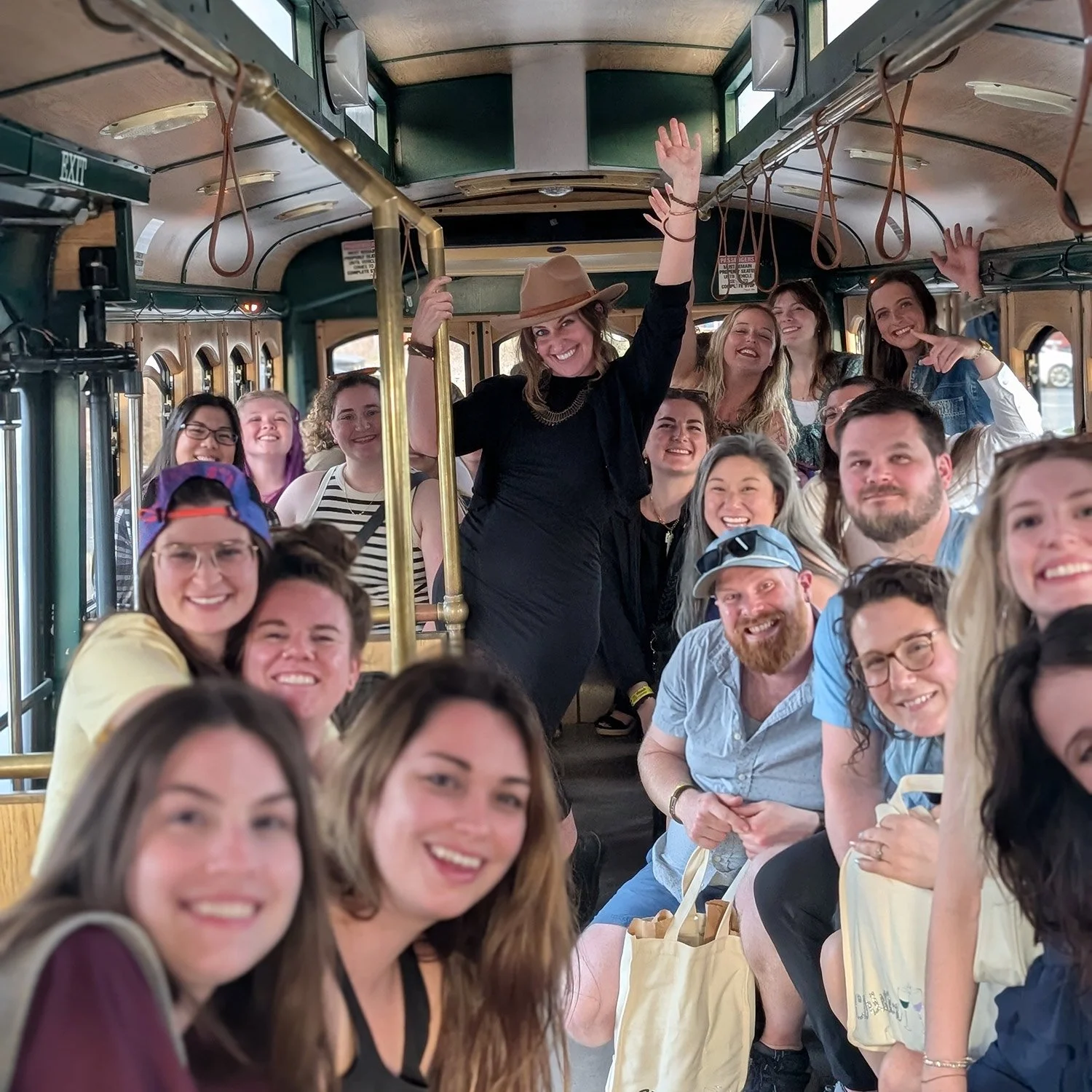 Guests riding together inside the Lakeside Trolley on a Seneca Lake wine tour