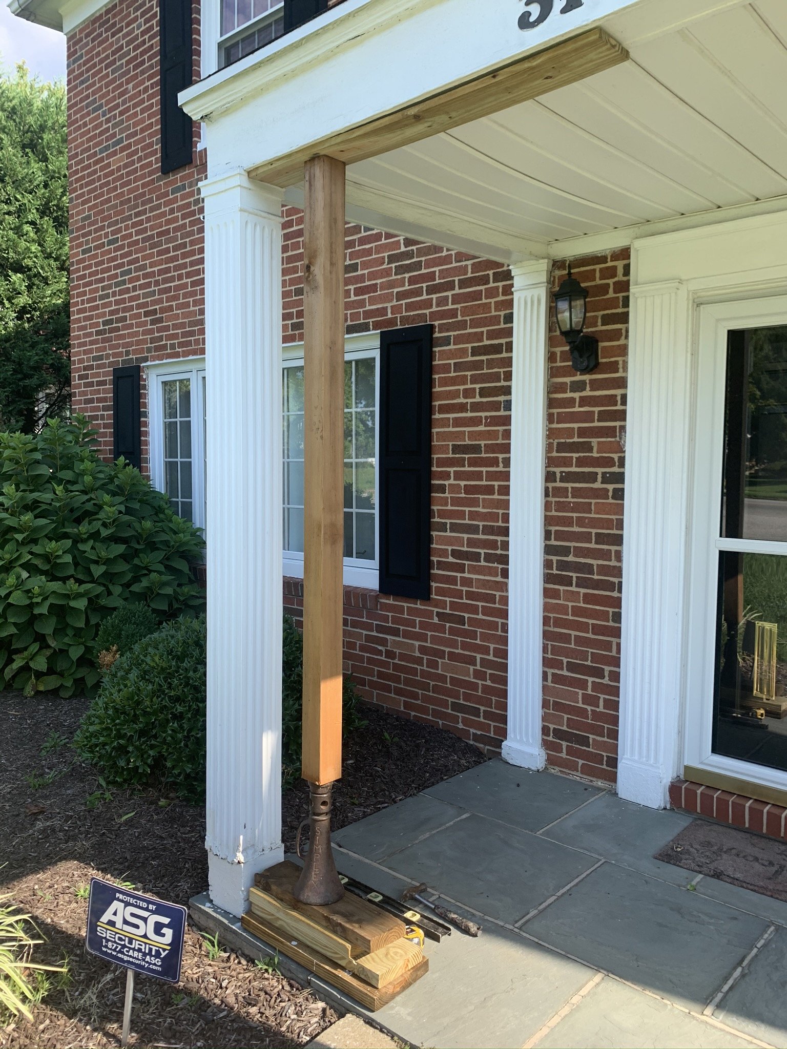 Roof temporarily jacked up to replace post and level roof