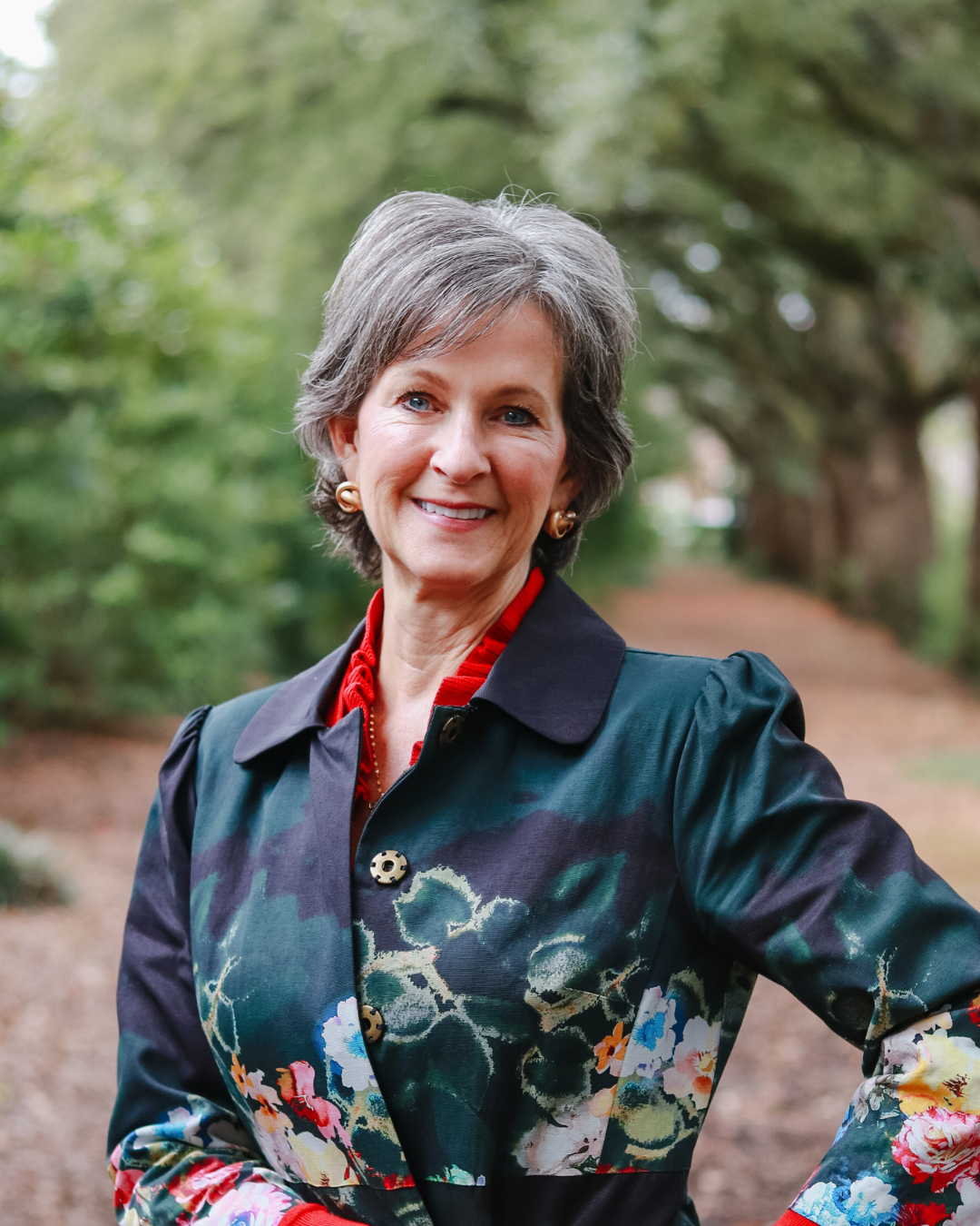 Smiling woman in floral shirt outdoors