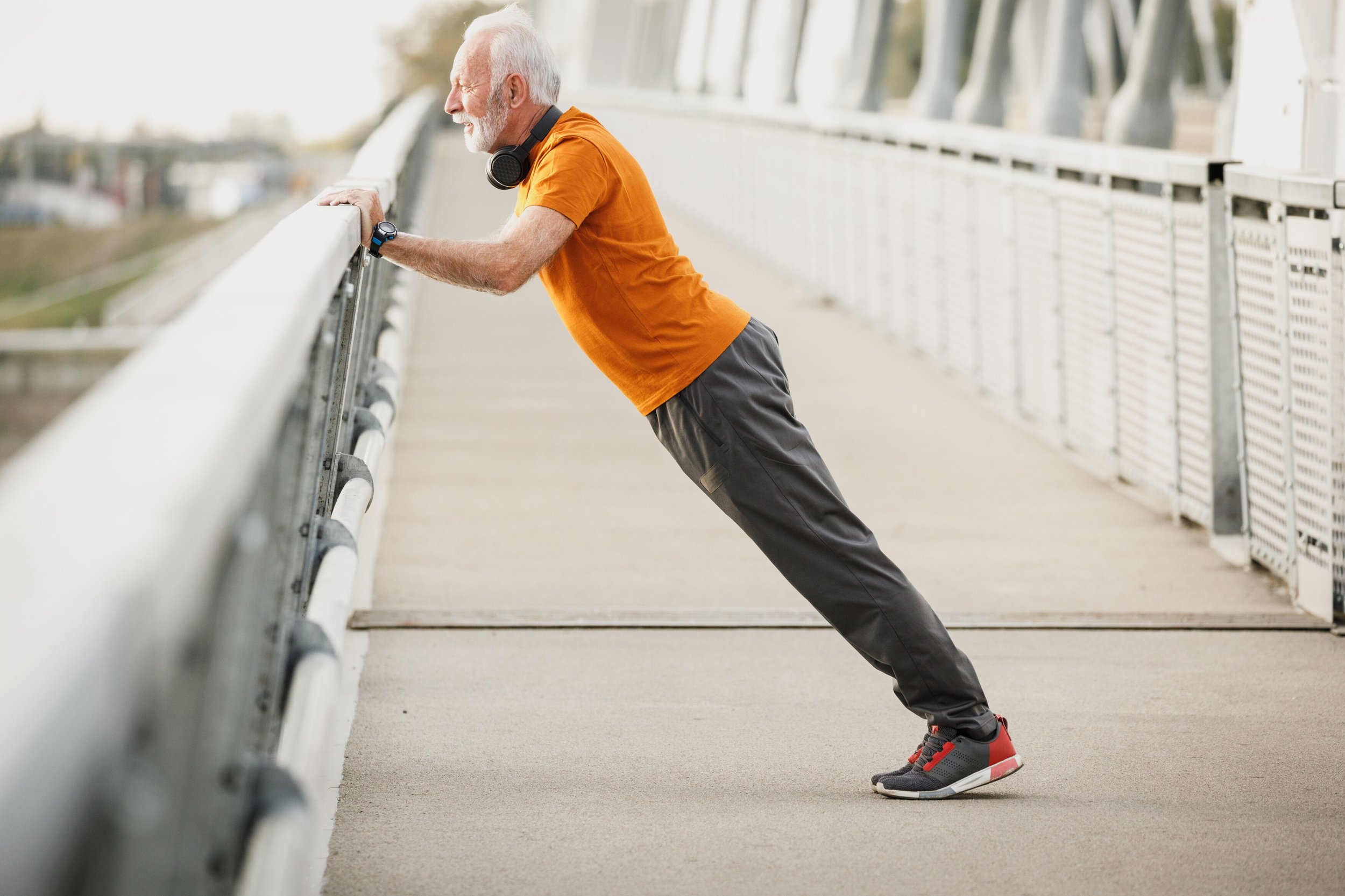 Old guy exercising on bridge.jpg