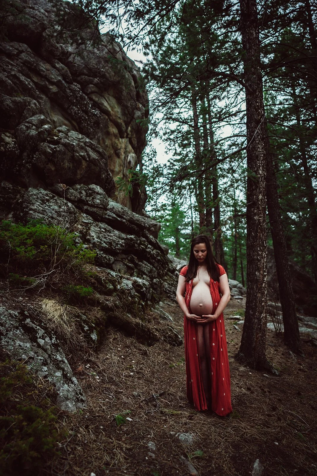 denver maternity photo of woman standing in the forest