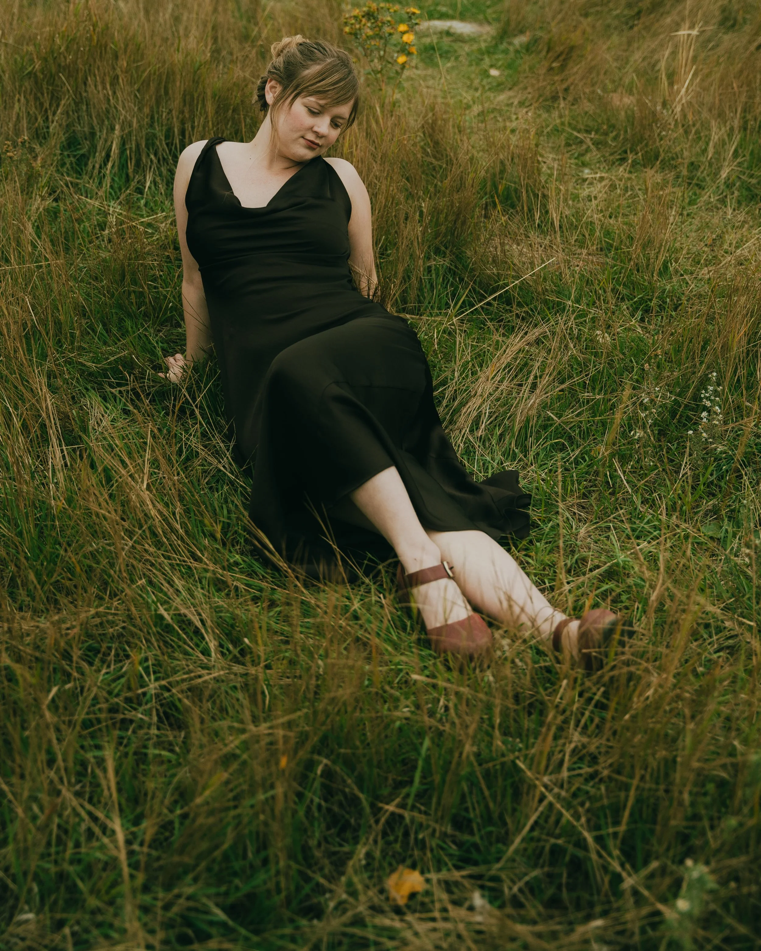  Fall senior portraits at South Mesa Trailhead in Boulder, Colorado featuring girl sitting in golden field.   