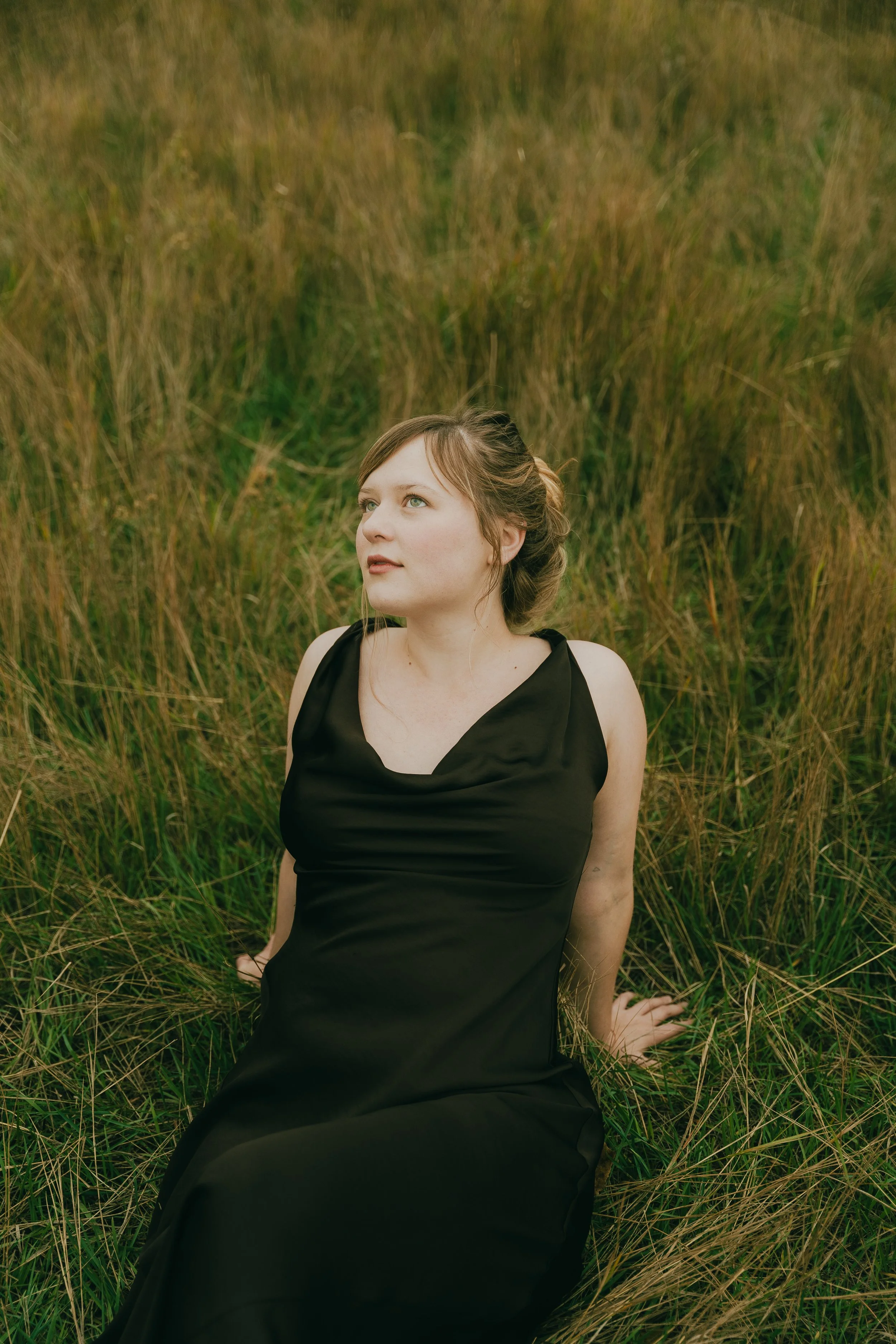  Fall senior portraits at South Mesa Trailhead in Boulder, Colorado featuring girl sitting in golden field.   