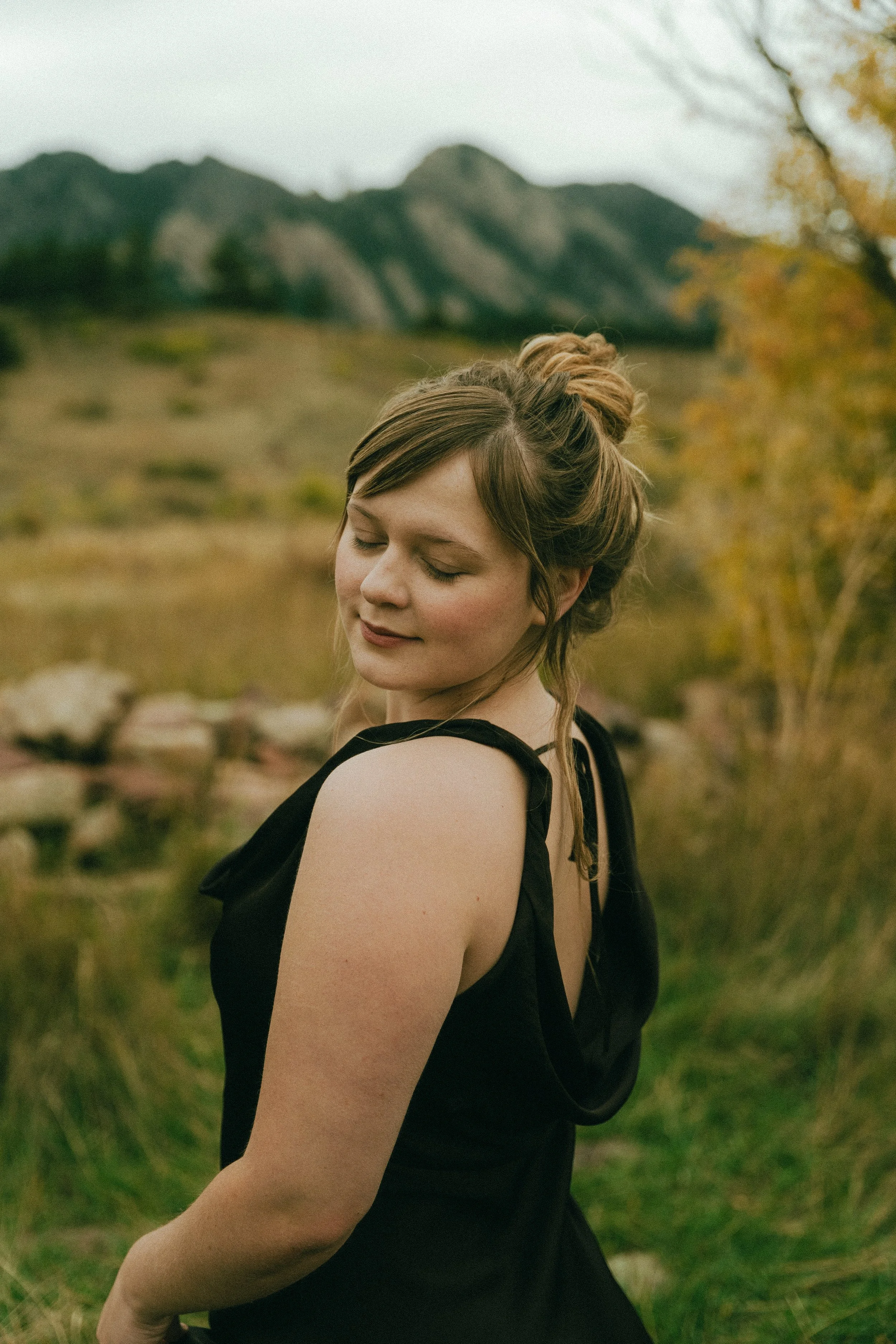  Fall senior portraits at South Mesa Trailhead in Boulder, Colorado featuring girl sitting in golden field.   