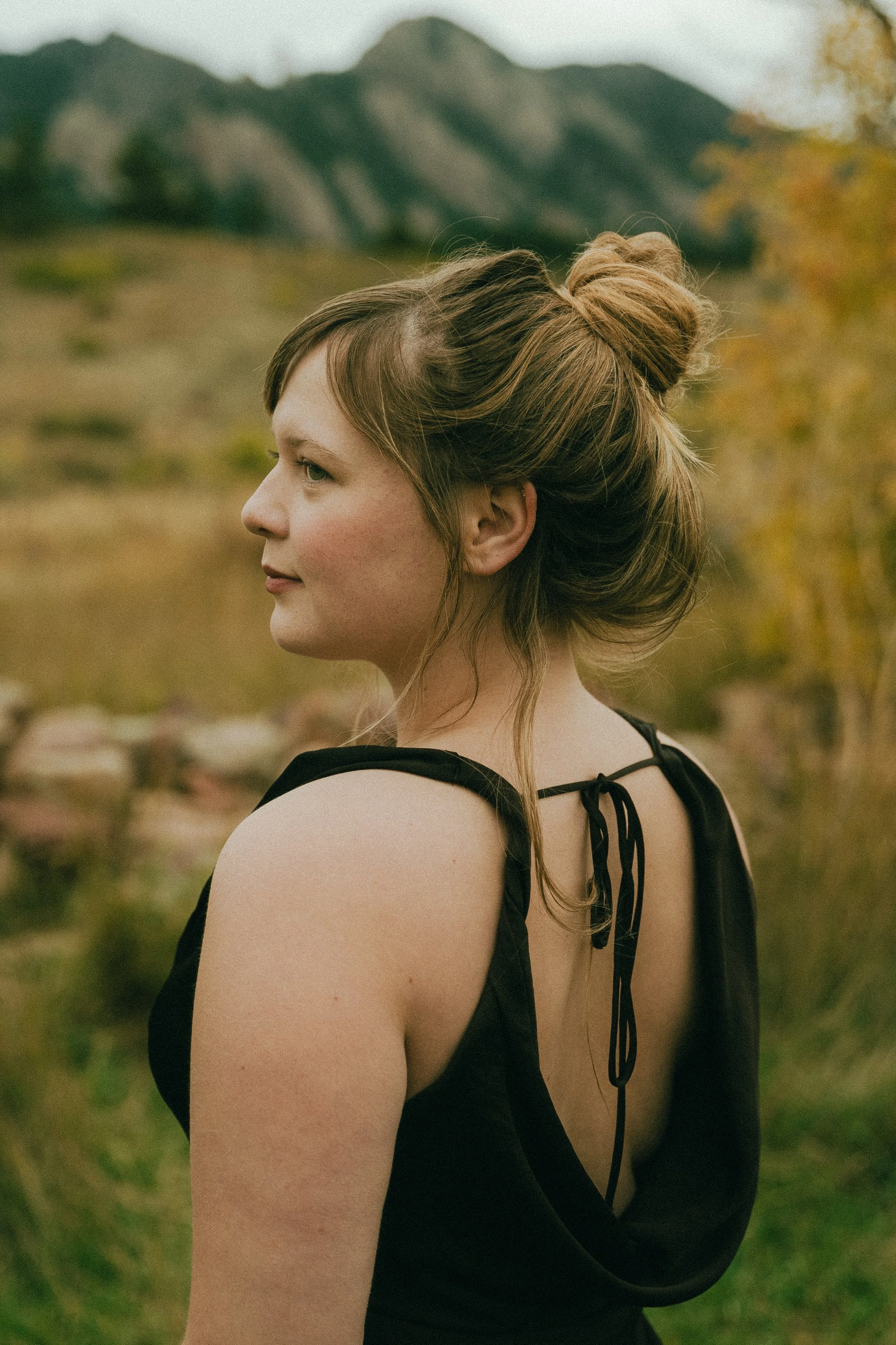 Fall senior portraits at South Mesa Trailhead in Boulder, Colorado featuring girl sitting in golden field.   