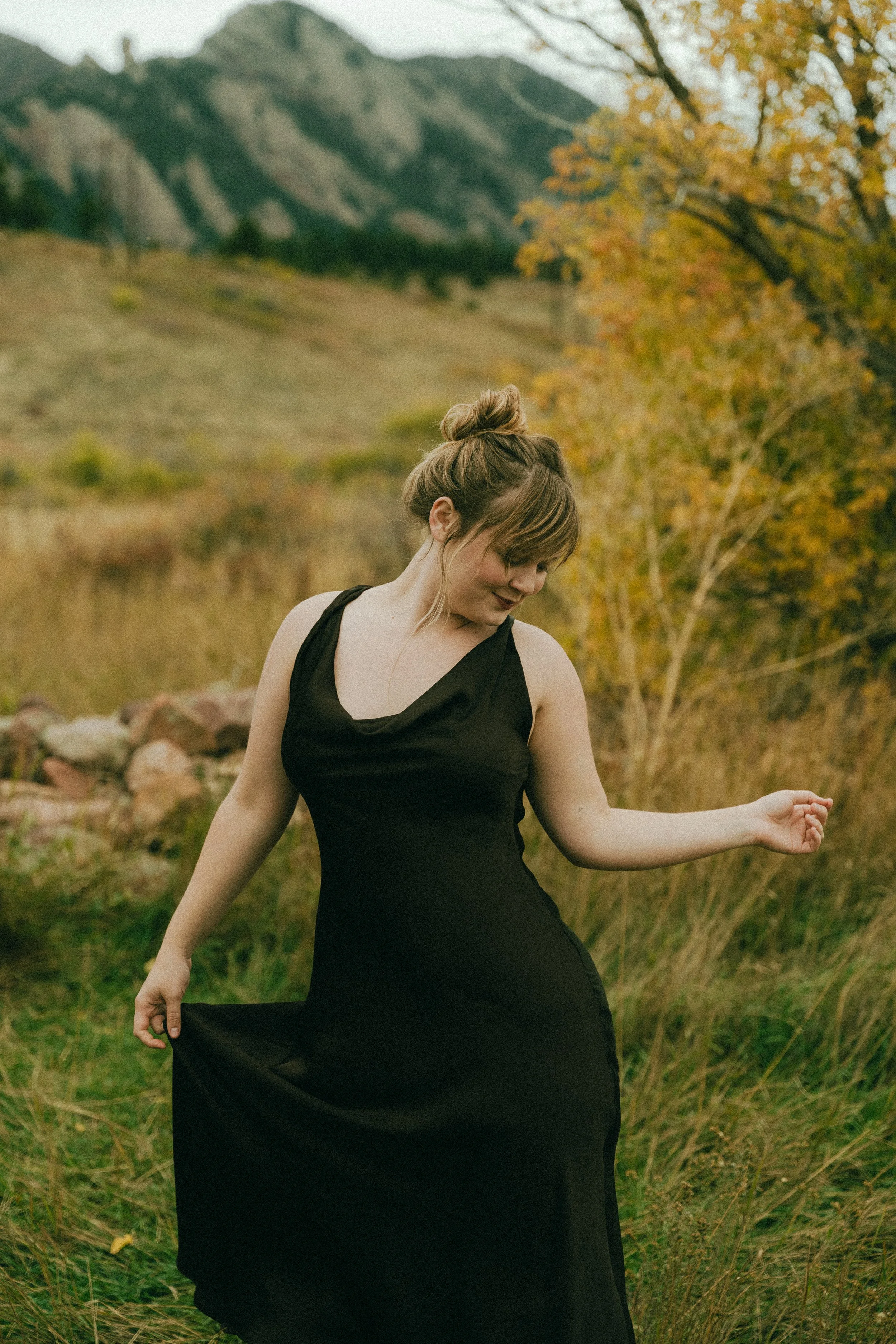  Fall senior portraits at South Mesa Trailhead in Boulder, Colorado featuring girl sitting in golden field.   