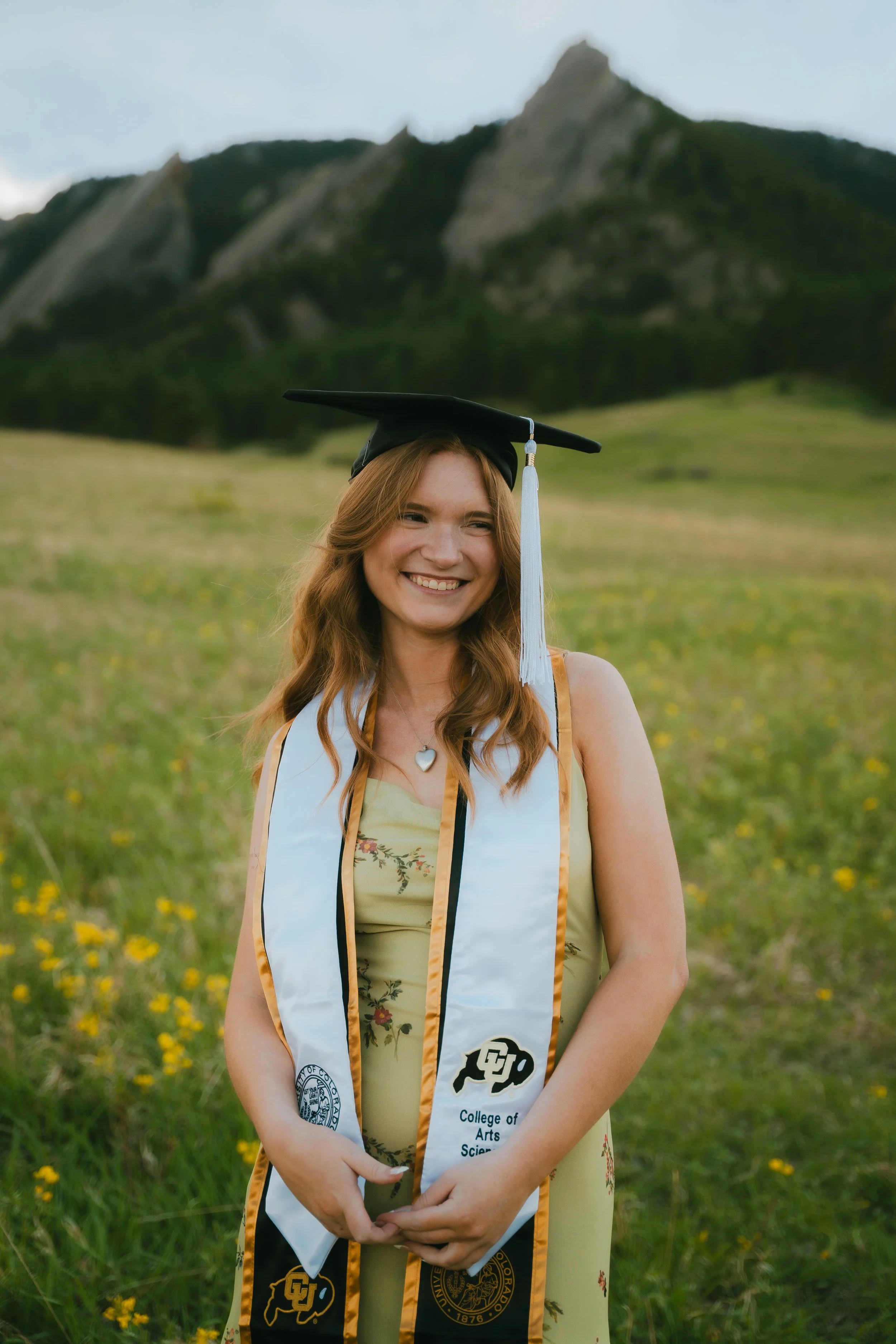  Senior portraits in Boulder, Colorado featuring girl running through colorful summer wildflower field.   