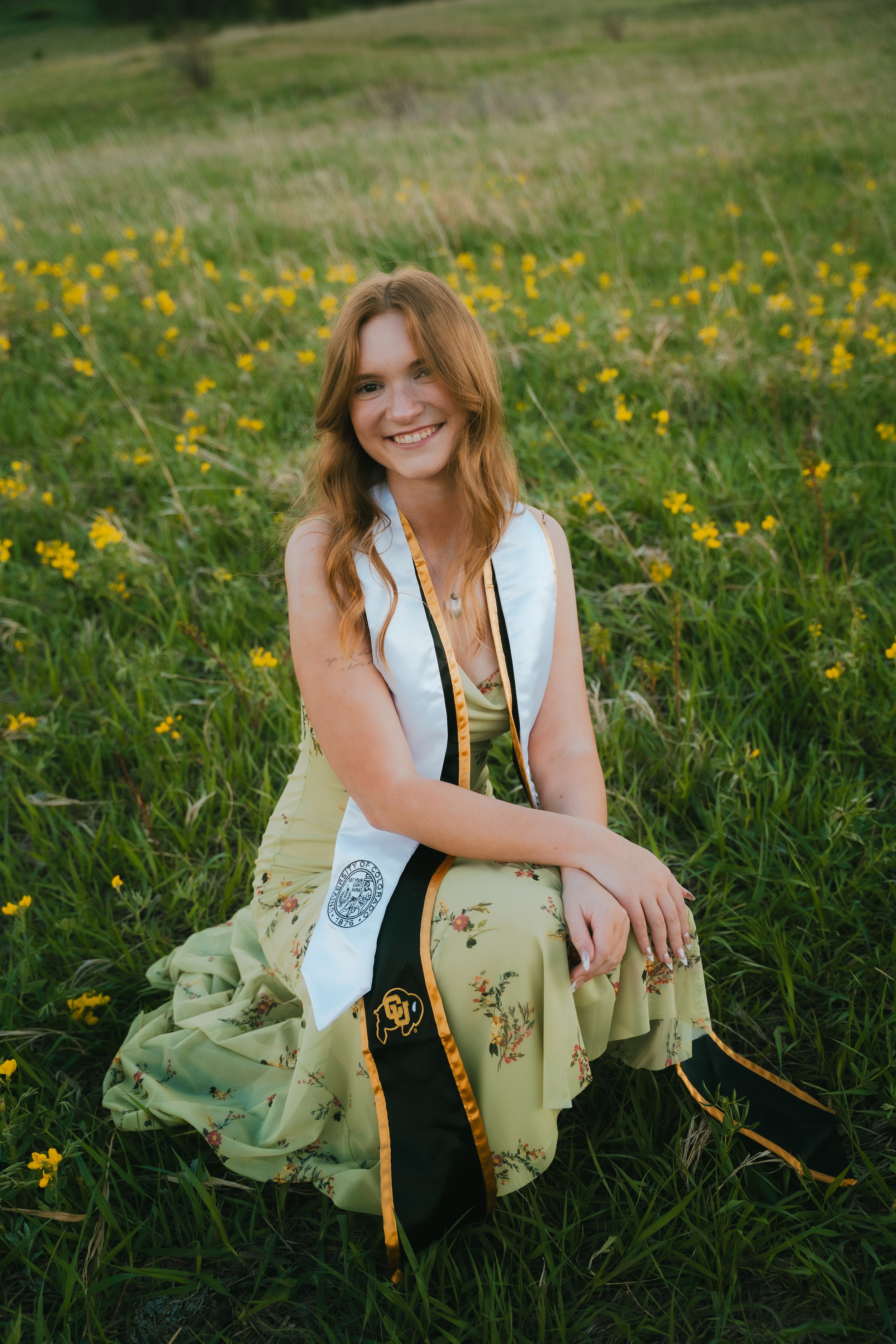  Senior portraits in Boulder, Colorado featuring girl running through colorful summer wildflower field at Chautauqua Park.  