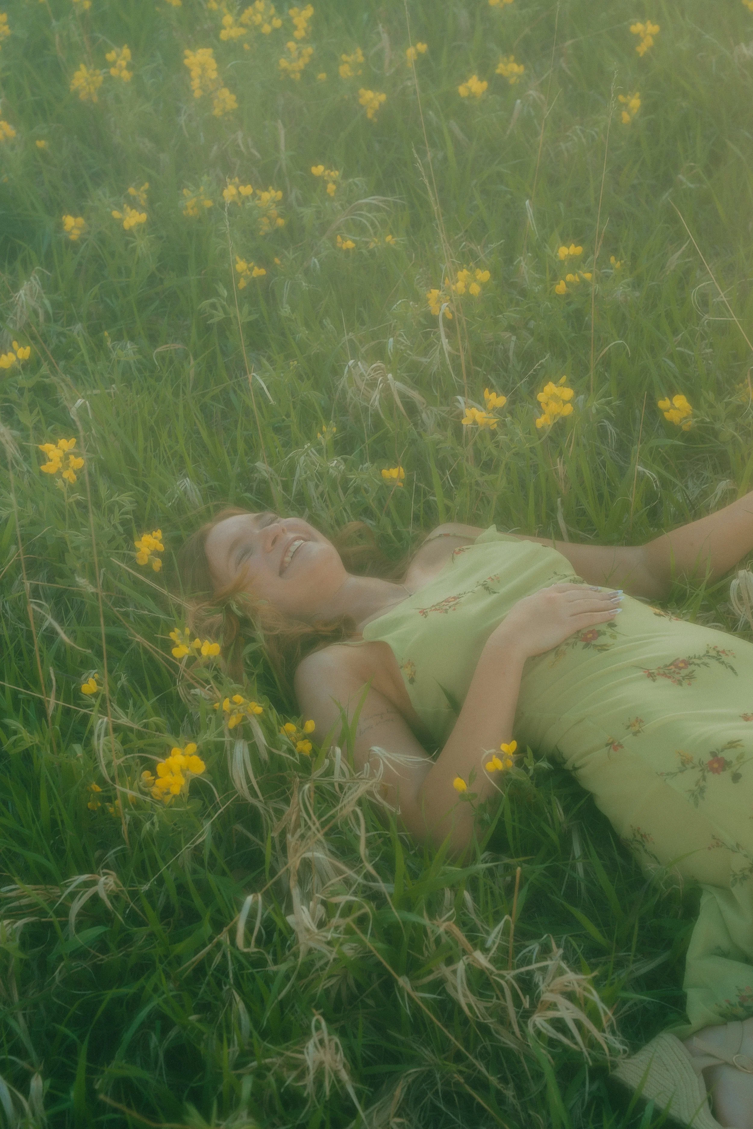  Senior portraits in Boulder, Colorado featuring girl running through colorful summer wildflower field at Chautauqua Park.    