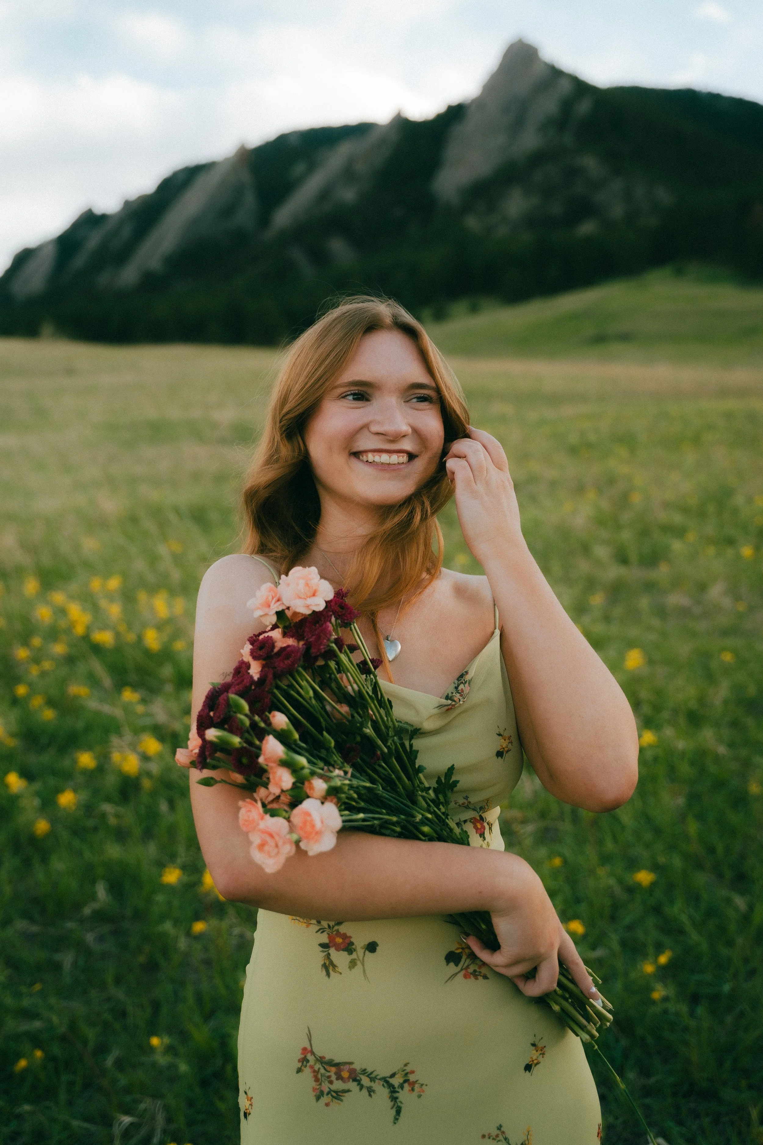  Senior portraits in Boulder, Colorado featuring girl running through colorful summer wildflower field at Chautauqua Park.  