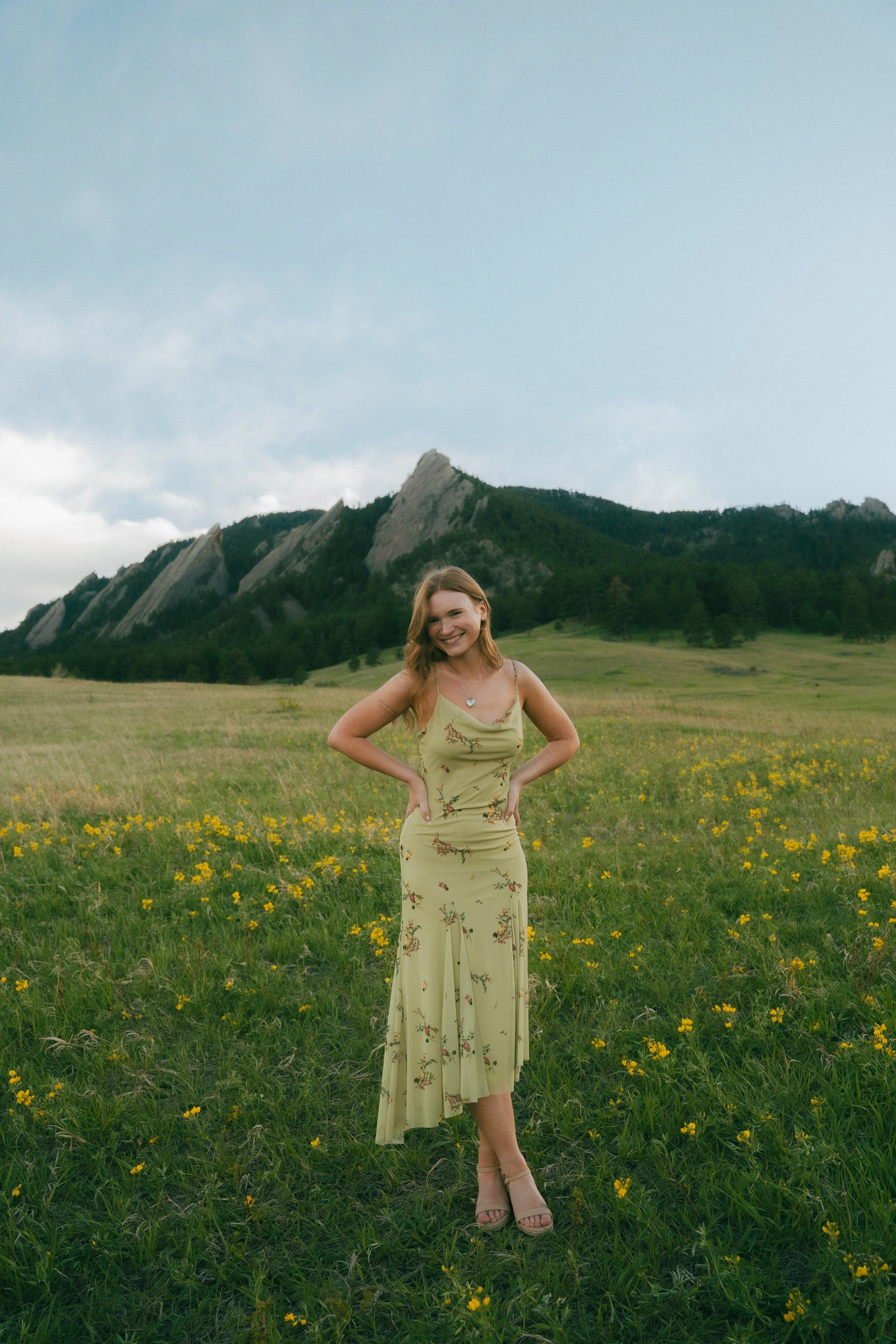  Senior portraits in Boulder, Colorado featuring girl running through colorful summer wildflower field at Chautauqua Park.  