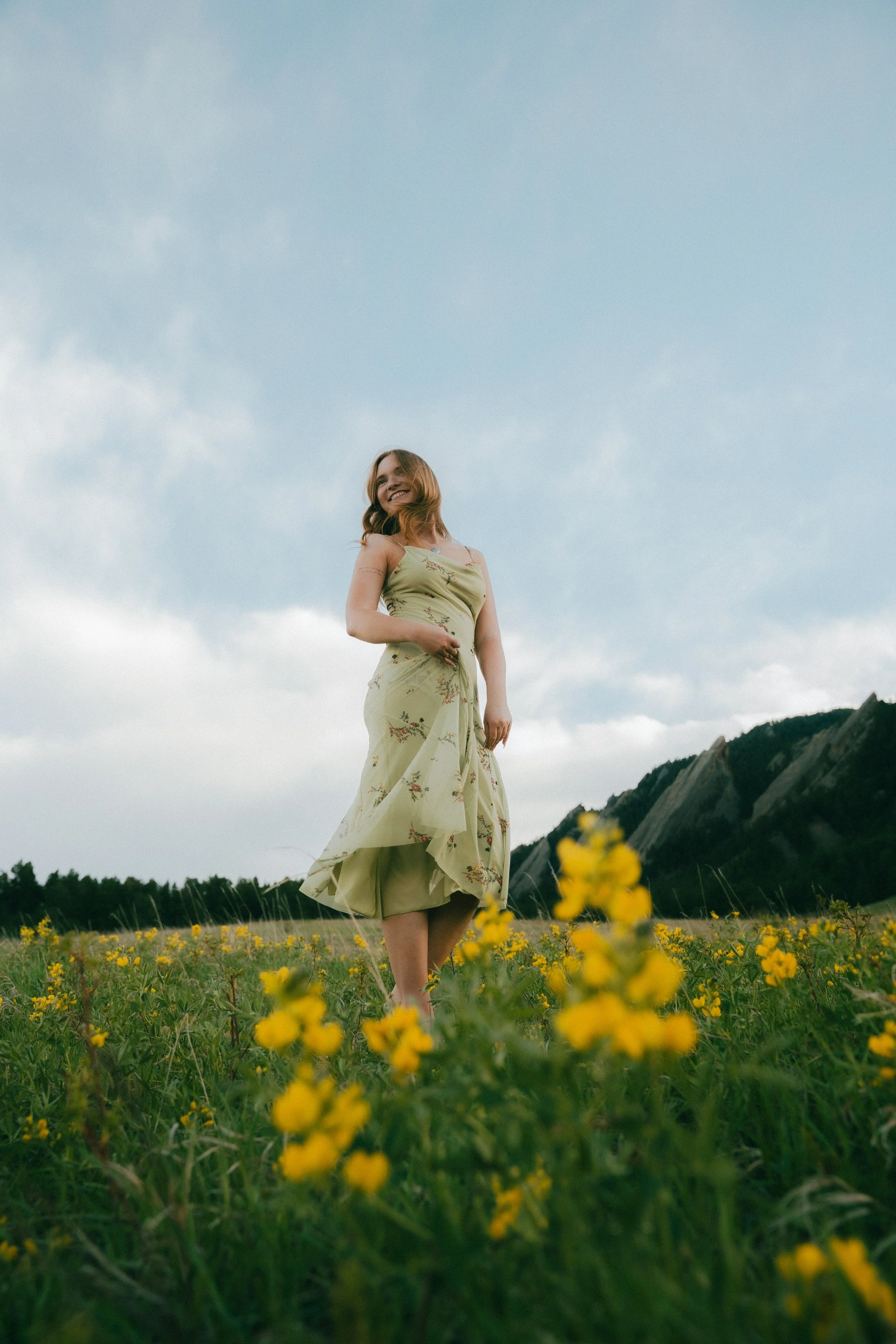  Senior portraits in Boulder, Colorado featuring girl running through colorful summer wildflower field.   