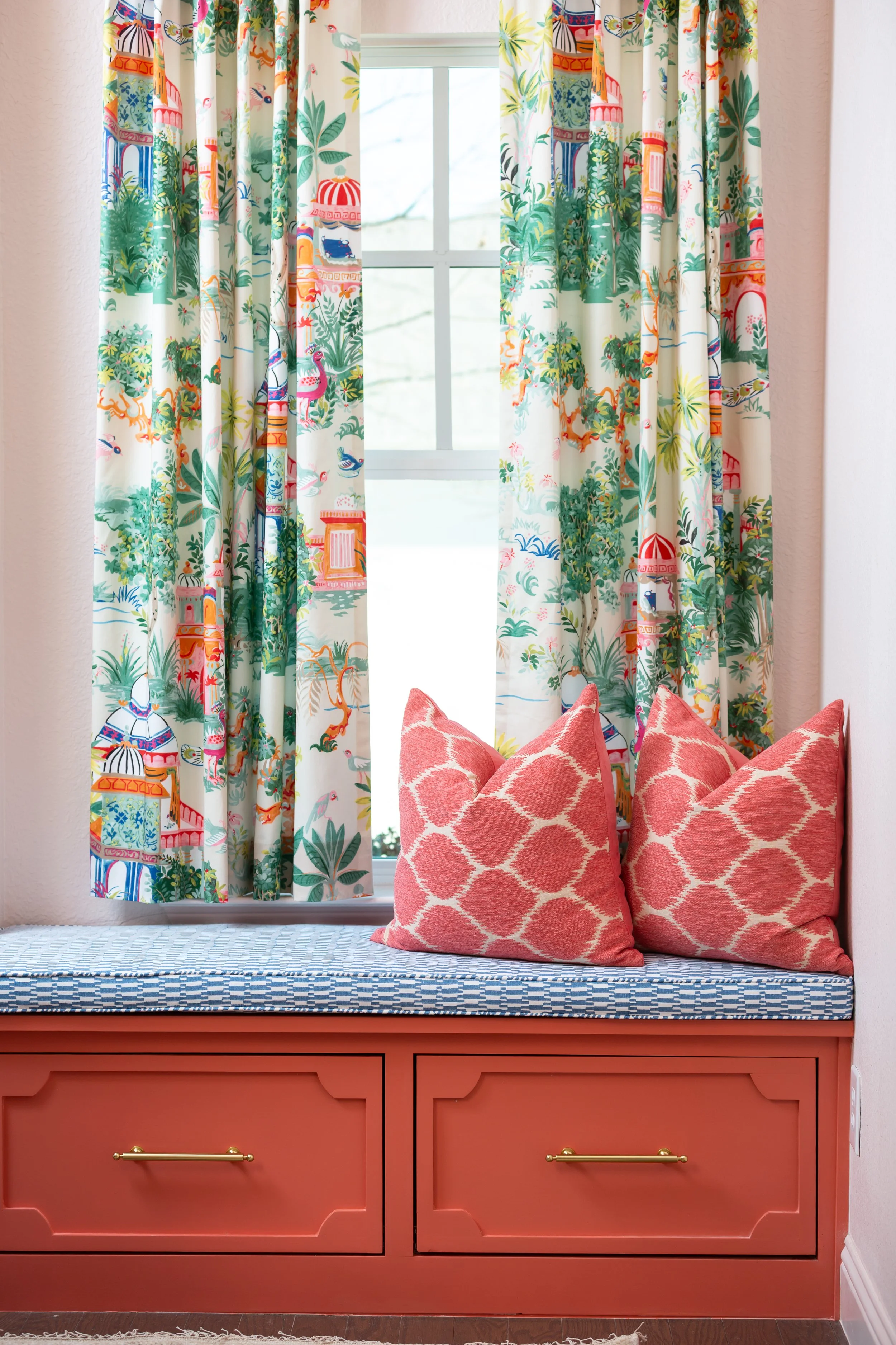 Custom window seat with built-in cabinetry and designer drapery illustrating how successful remodels require coordinated planning beyond simply choosing beautiful finishes.