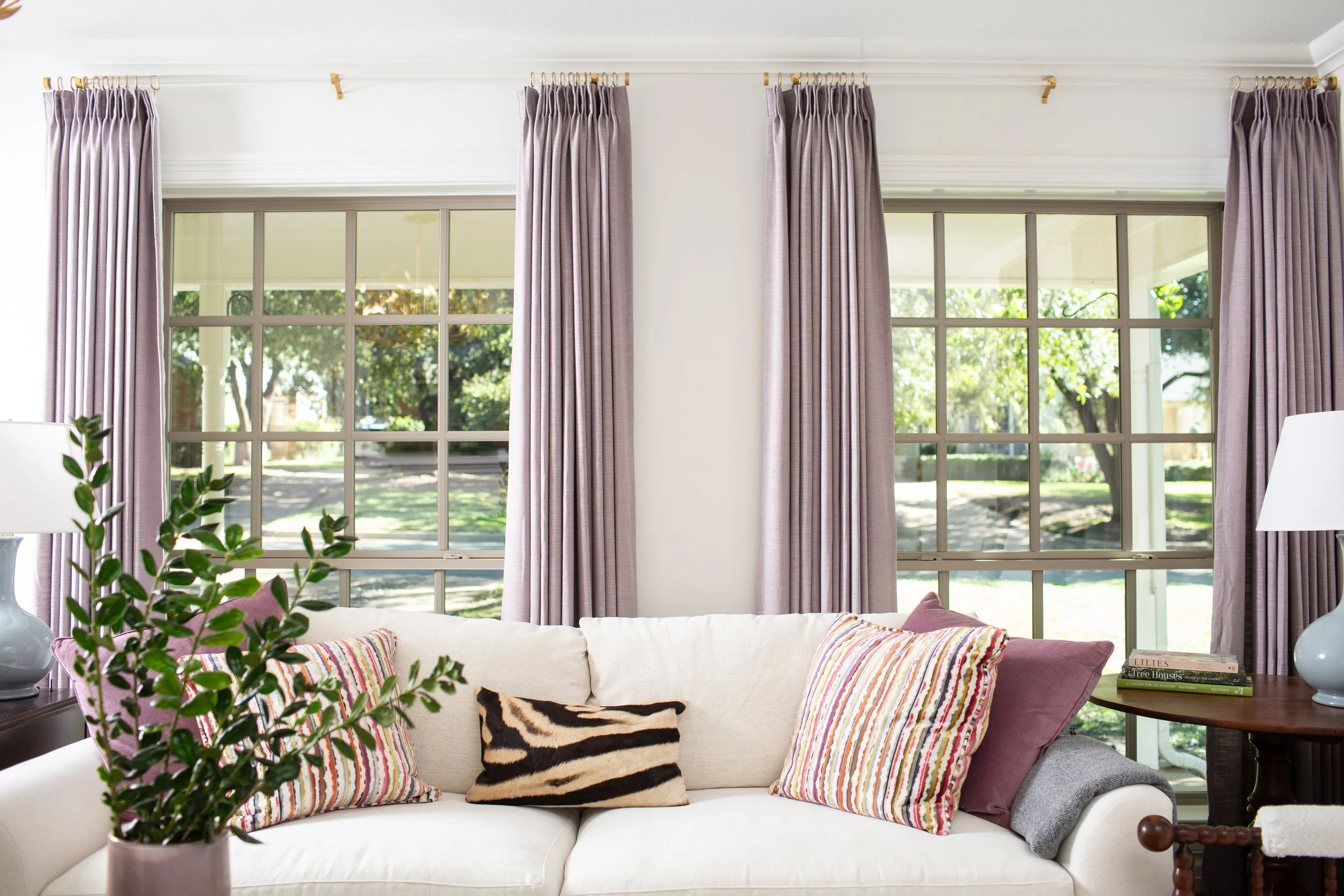 Light-filled living room featuring custom furnishings, drapery, and styling by MASH Habitat Interiors in Fort Worth, Texas.