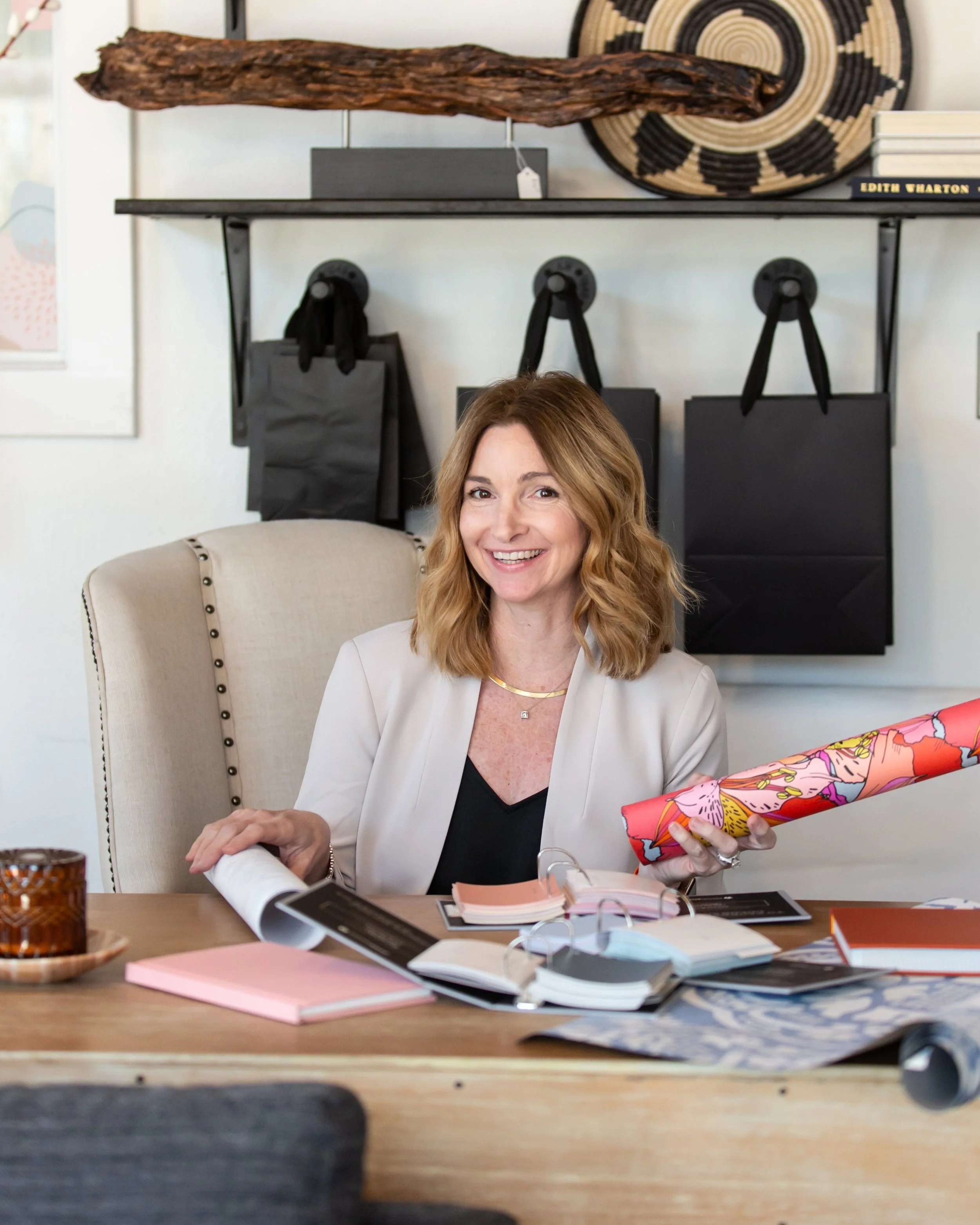 Interior designer reviewing paint colors, wallpaper samples, and finish selections during a design consultation in Fort Worth, Texas