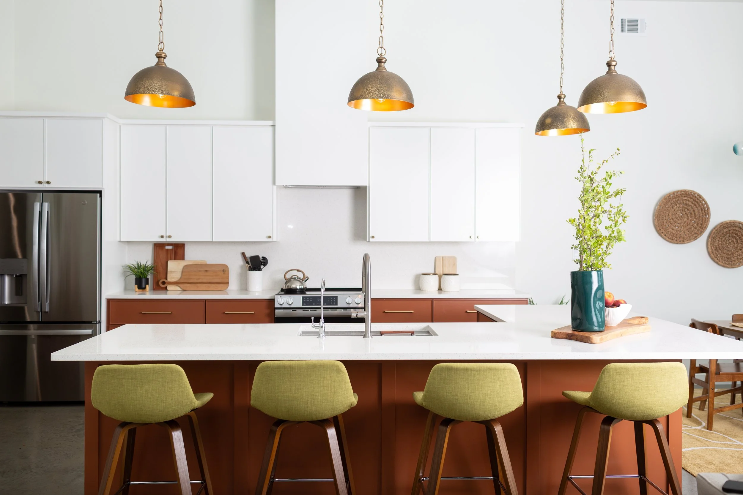 Custom kitchen design with warm cabinetry, pendant lighting, and island seating by Fort Worth interior designer MASH Habitat Interiors.