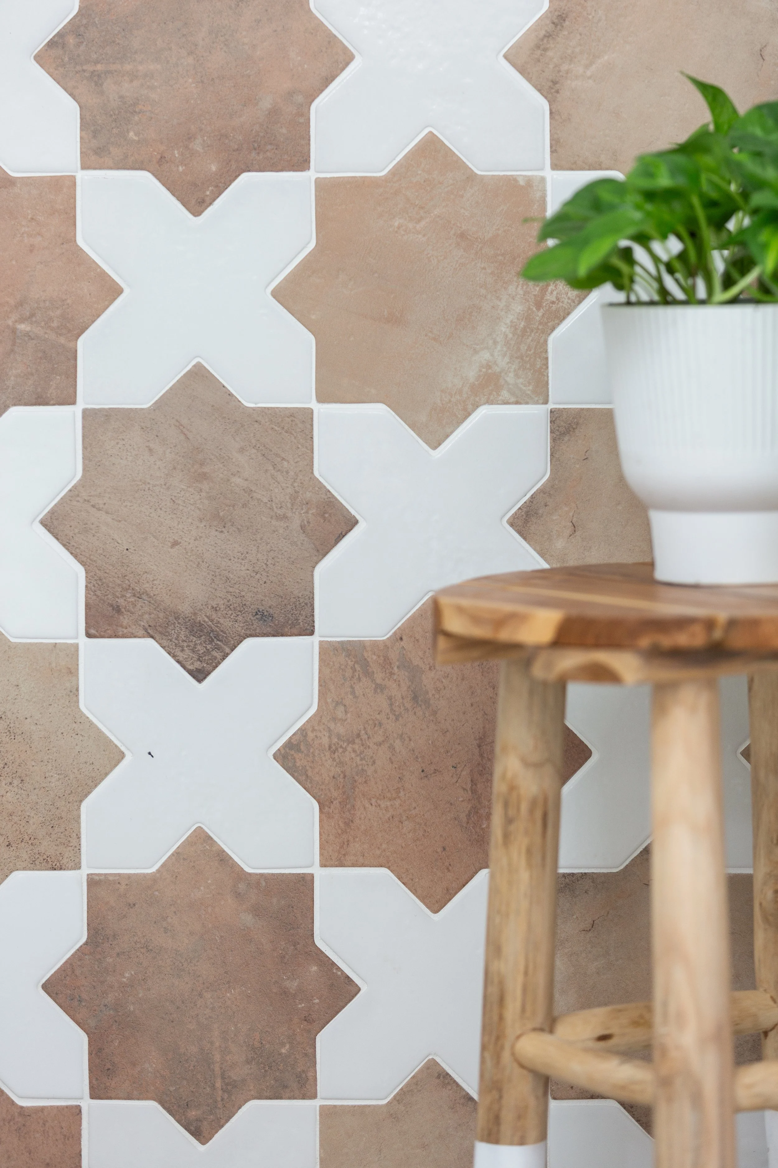 Decorative tile detail with warm neutral finishes and natural wood accents in a Fort Worth interior designed by MASH Habitat Interio