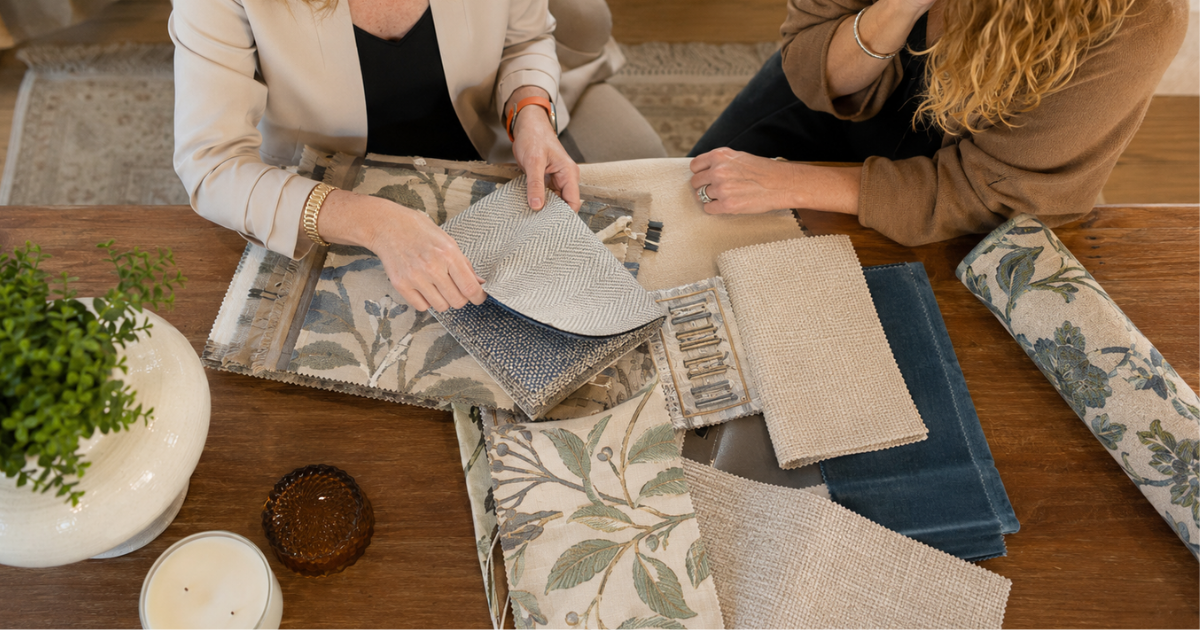 Interior designer helping a homeowner select coordinated fabrics and finishes during a remodeling project.