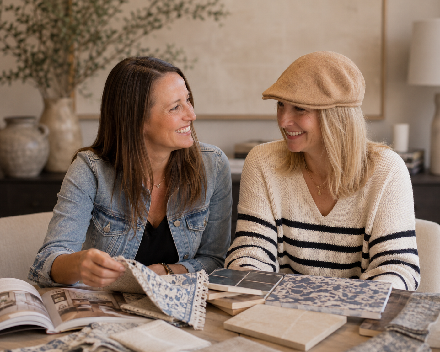 The MASH Habitat Interiors team reviewing fabrics, tile samples, and finishes for a custom home design project.