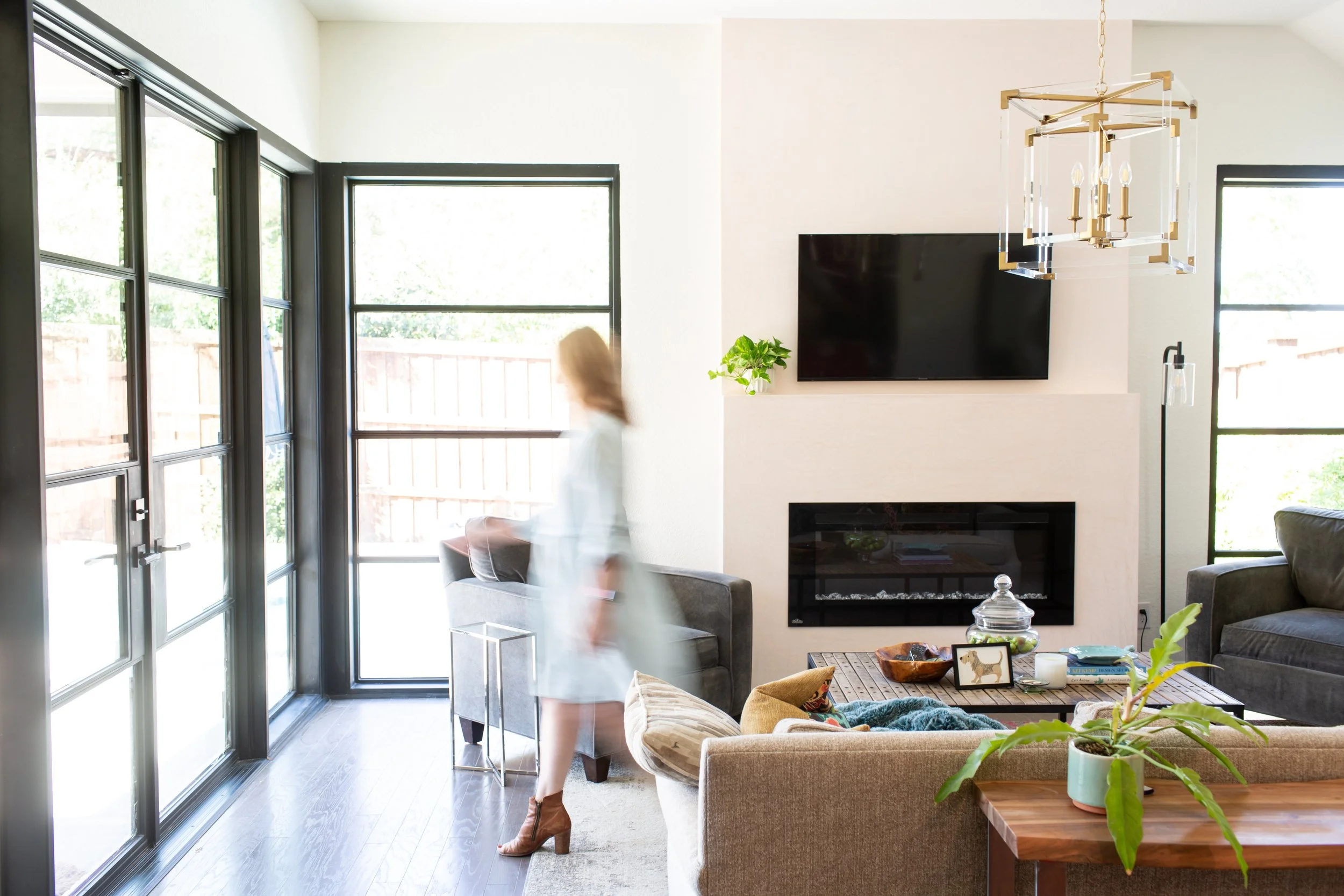 Interior designer Melanie Rosenburg walking through a custom-designed Fort Worth home.