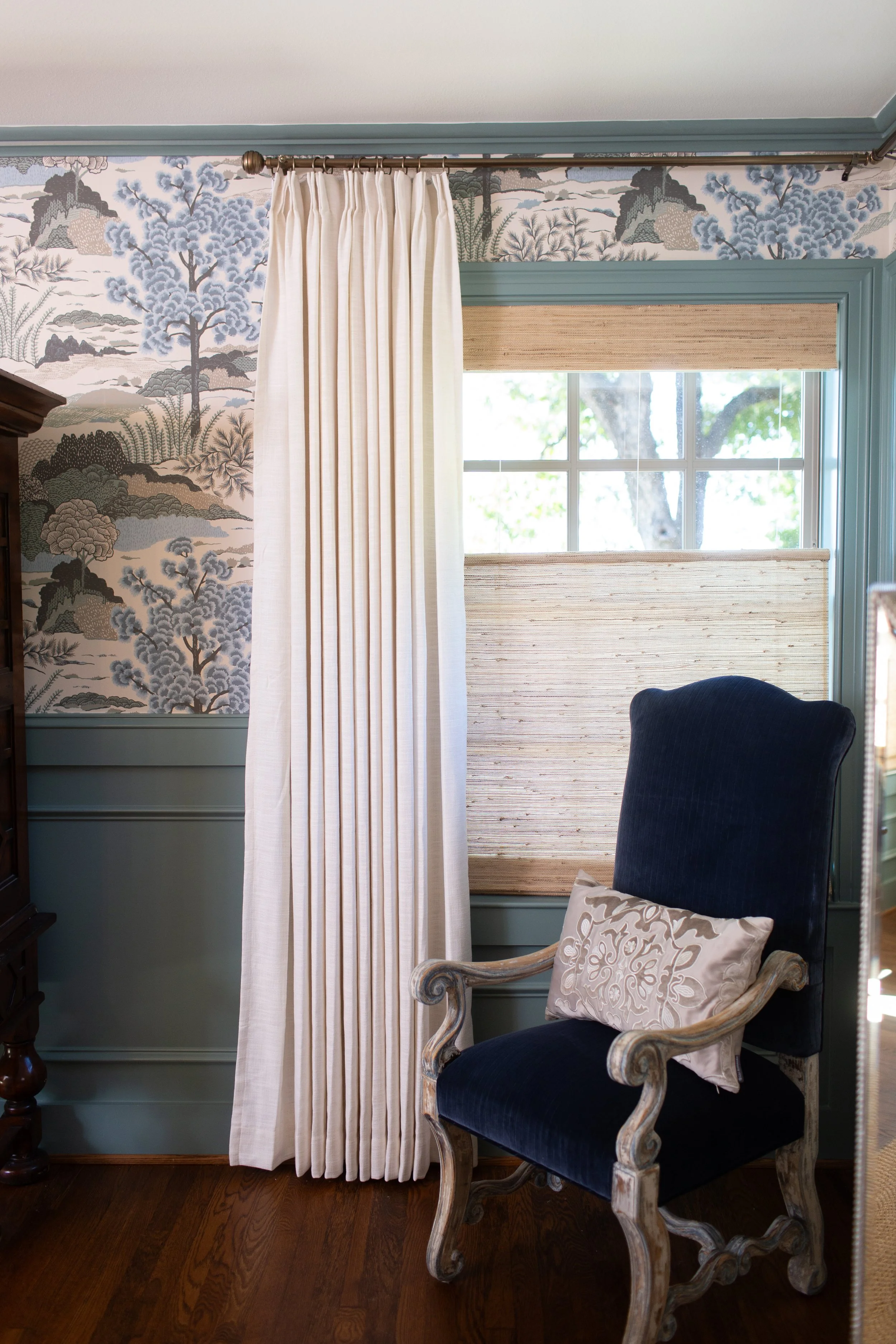 Traditional blue wallpaper accent wall in a luxury bedroom