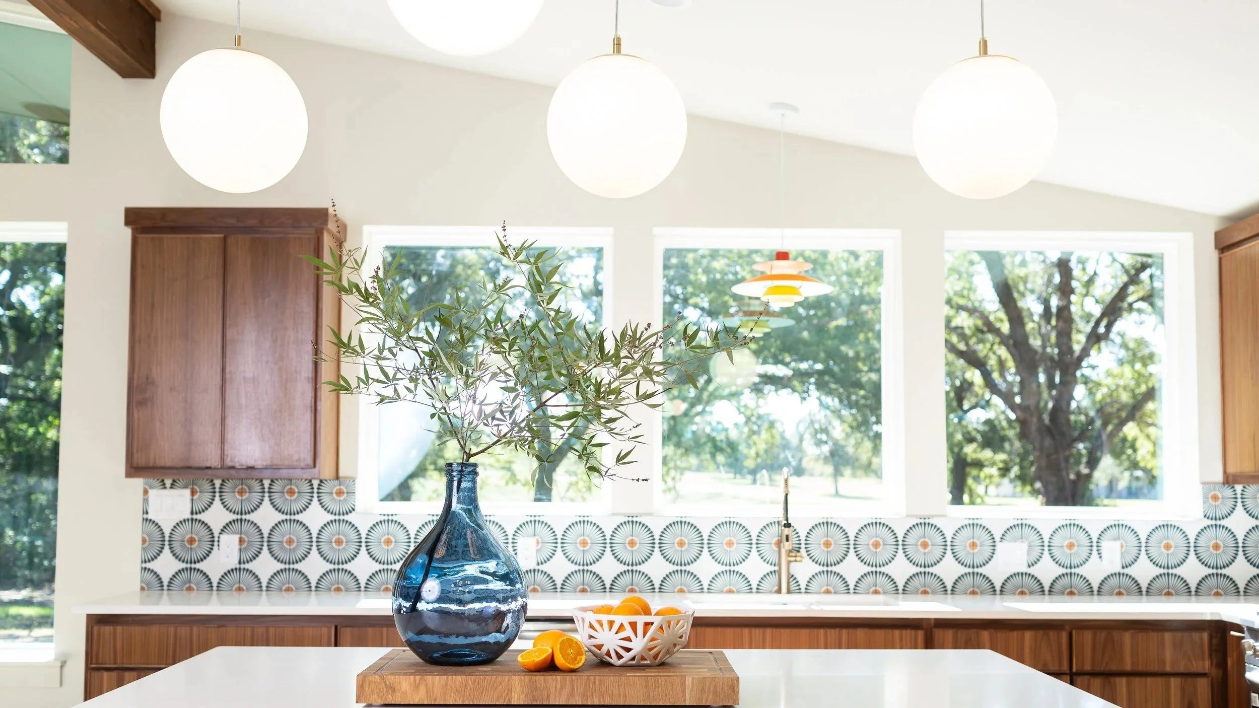 Fort Worth kitchen remodel featuring custom tile, warm wood cabinetry, decorative lighting, and personalized interior design by MASH Habitat Interiors.