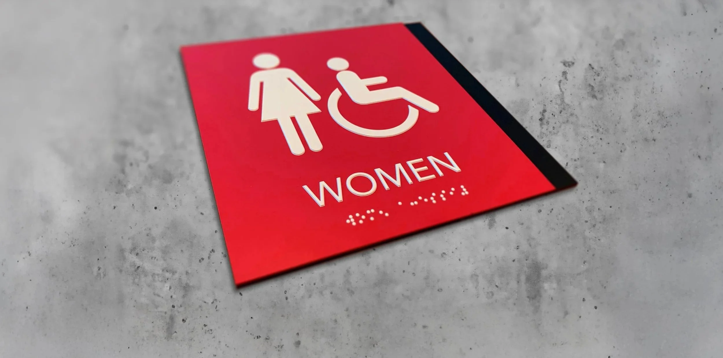 restroom sign with braille