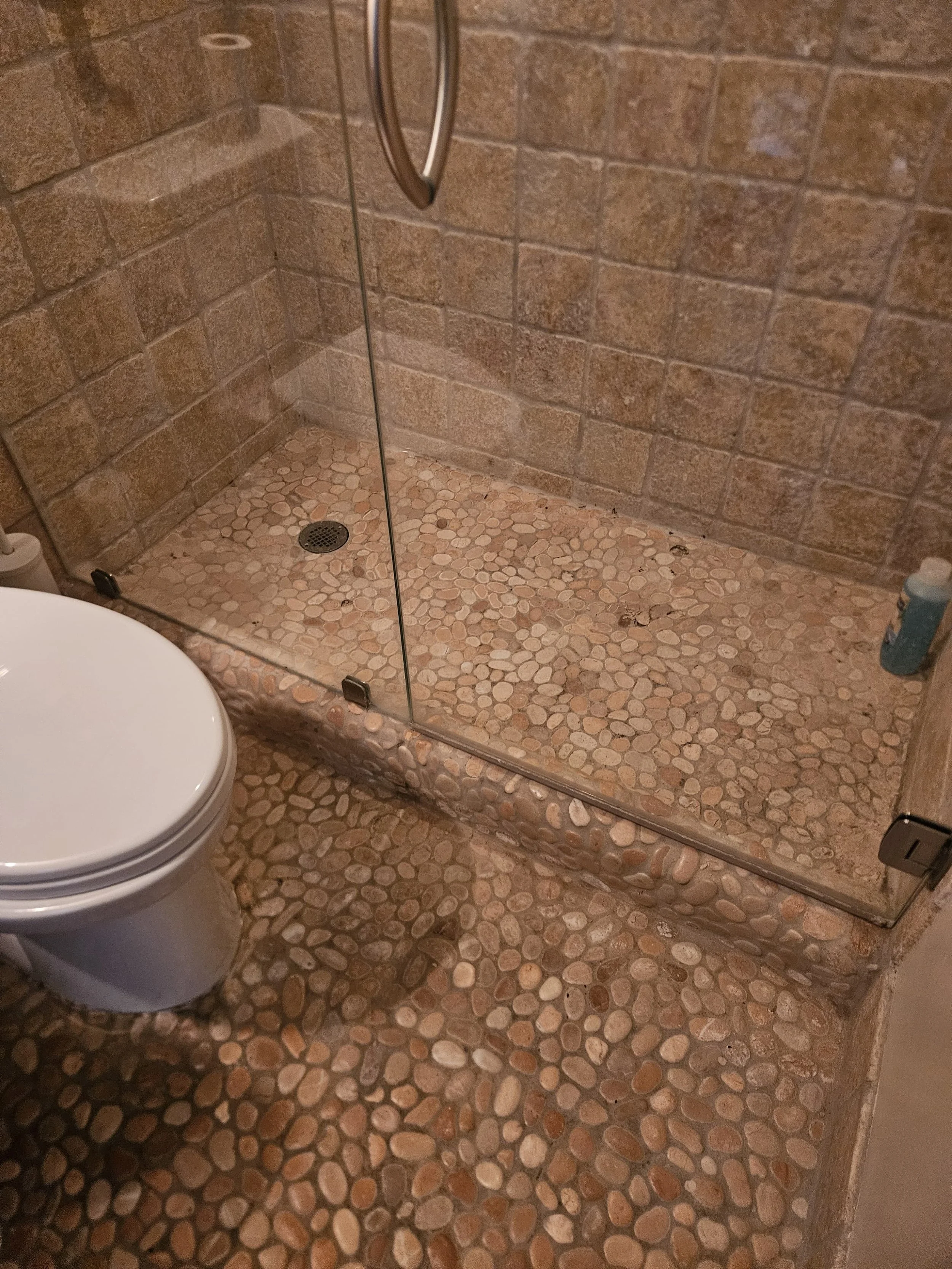 *BEFORE* Stone tiles were wearing thin in this shower.