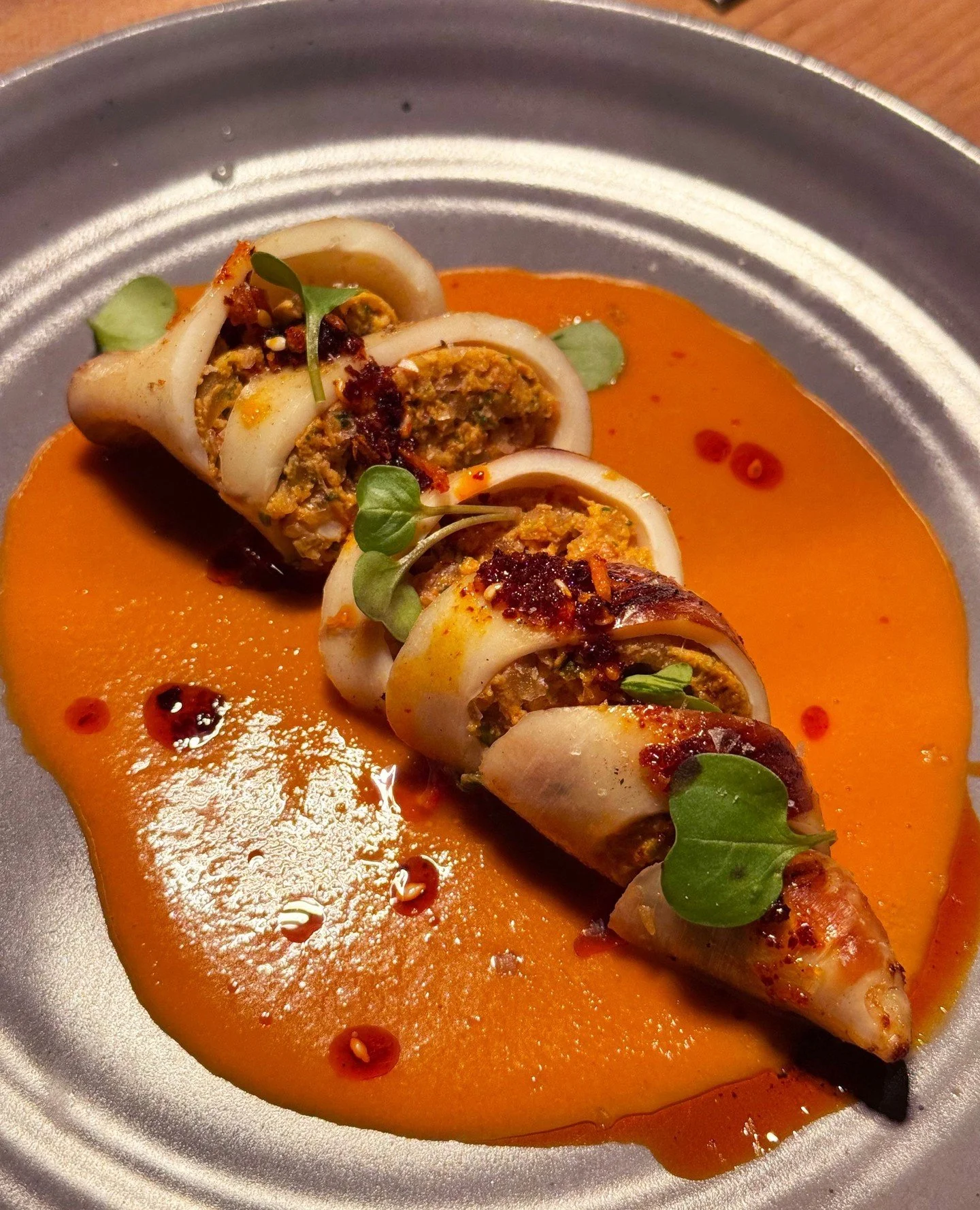Love seeing an old favorite get a new twist, like this squid dish at Brasero Chicago. ⁠
⁠
A note from Chef Brandon: It&rsquo;s a sofrito with ginger garlic, Fresno, Aji powder. Then we blitzed scallops and some of the tentacles and made a mouse with 