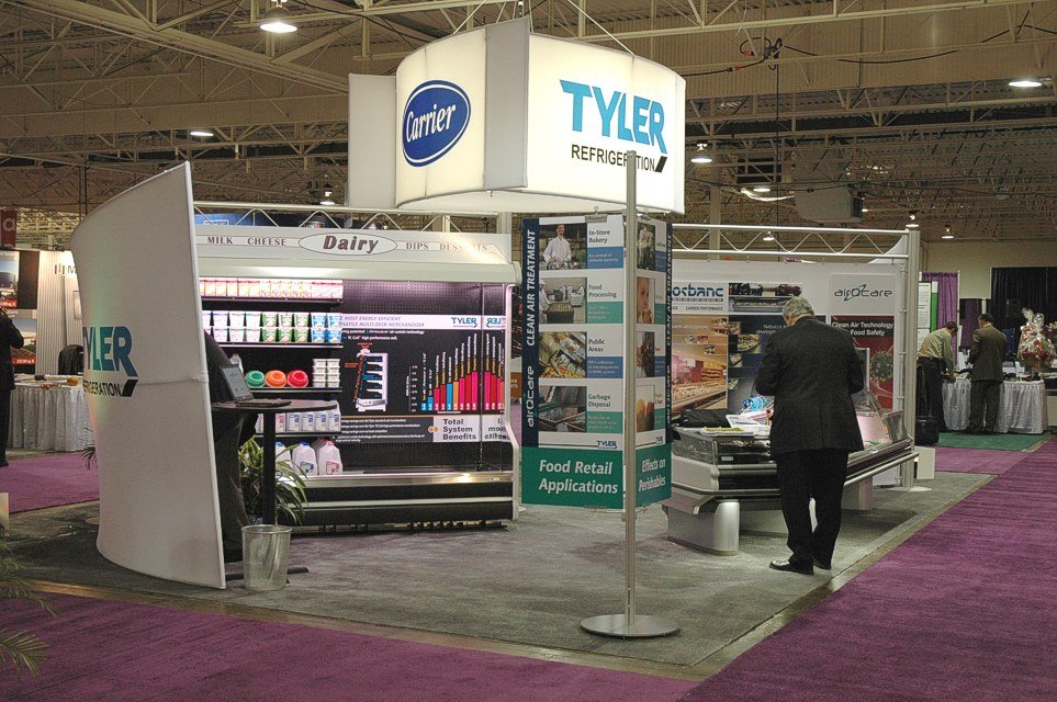 This is an example of how to successfully place four LARGE products (store merchandisers) into a 20'x30' space without the space looking overcrowded. The graphic sweeps on the two corners help to divide and visually segment the products. We purchased