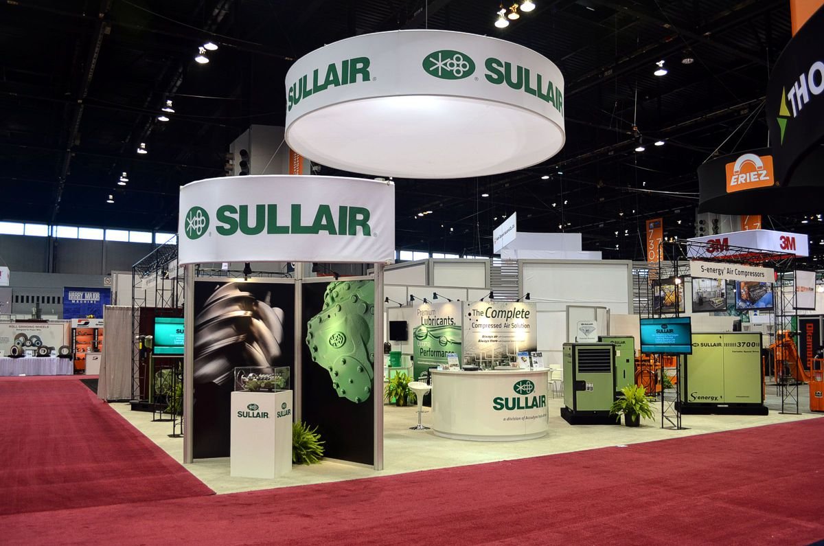Was able to secure an intersecting aisleway booth location, which increases walking traffic numbers and flow through the exhibit. a large "hockey puck" lighted header draws attention at a distance, and corner identity with intriguing photography and