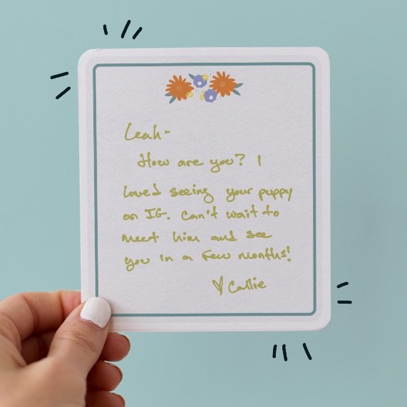Hand holding a handwritten greeting card