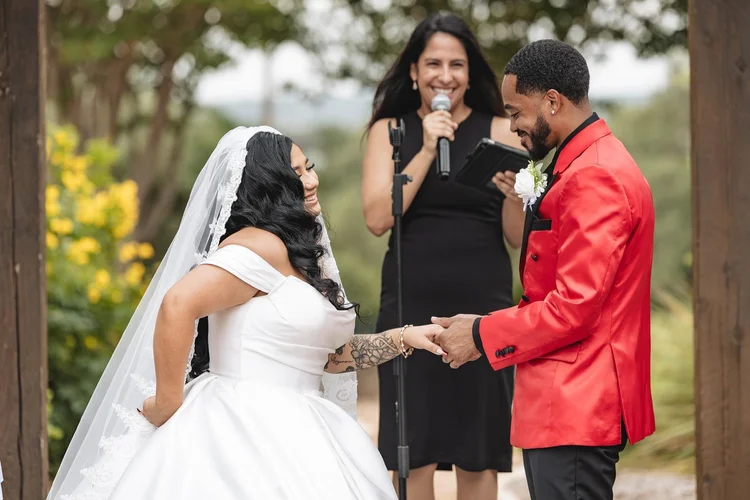 Wedding officiant celebrating with couple