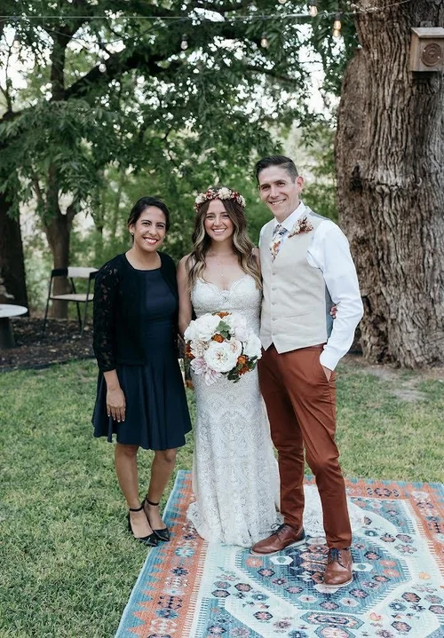 Wedding officiant with couple