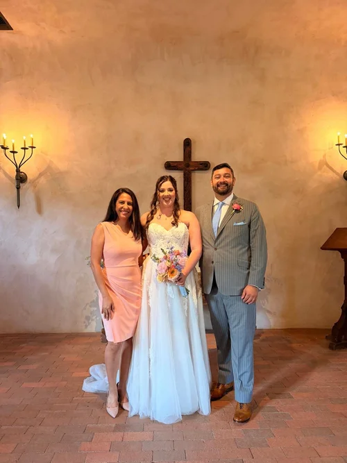 Wedding officiant celebrating with couple
