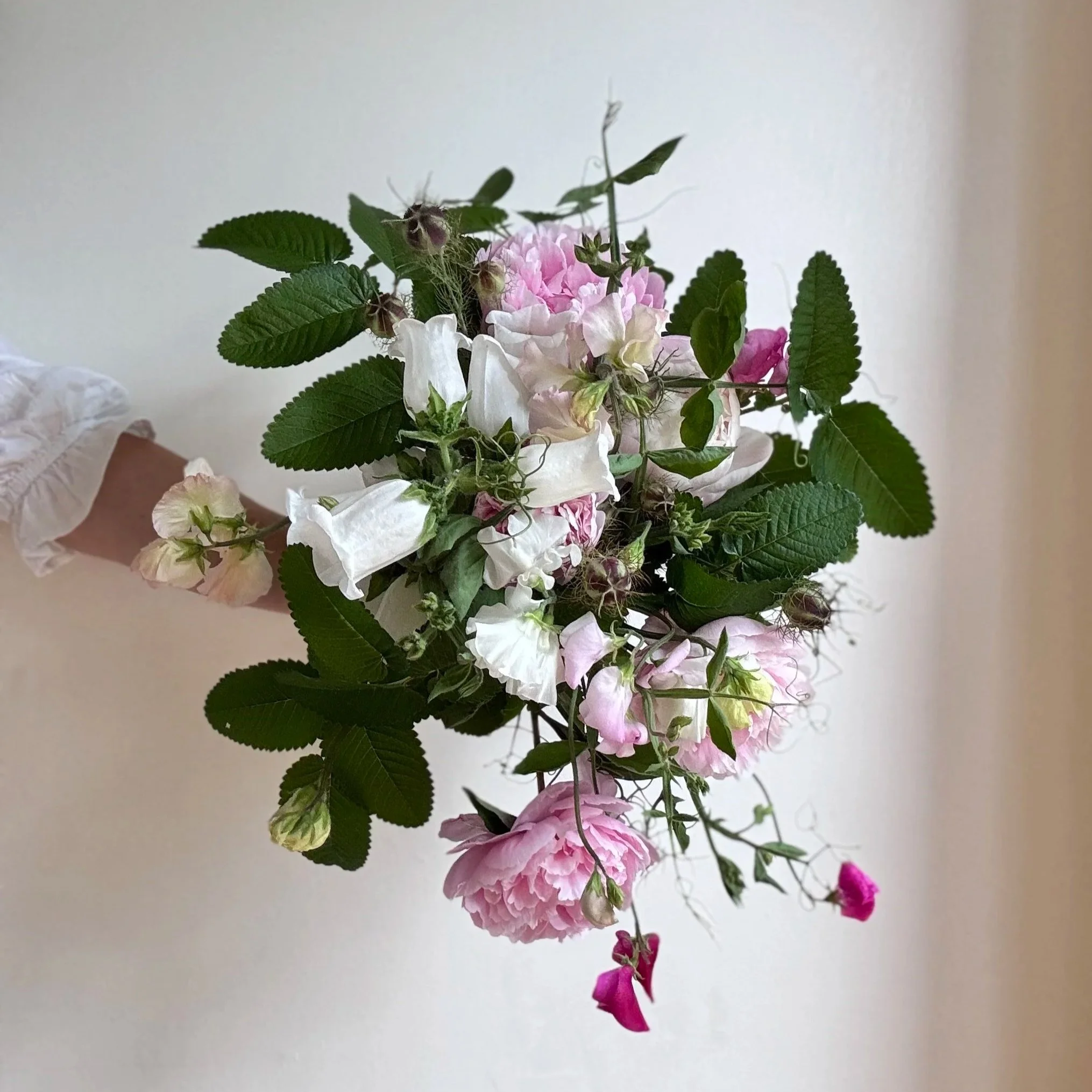 Hand-tied spring wedding bouquet in blush pink tones with seasonal flowers