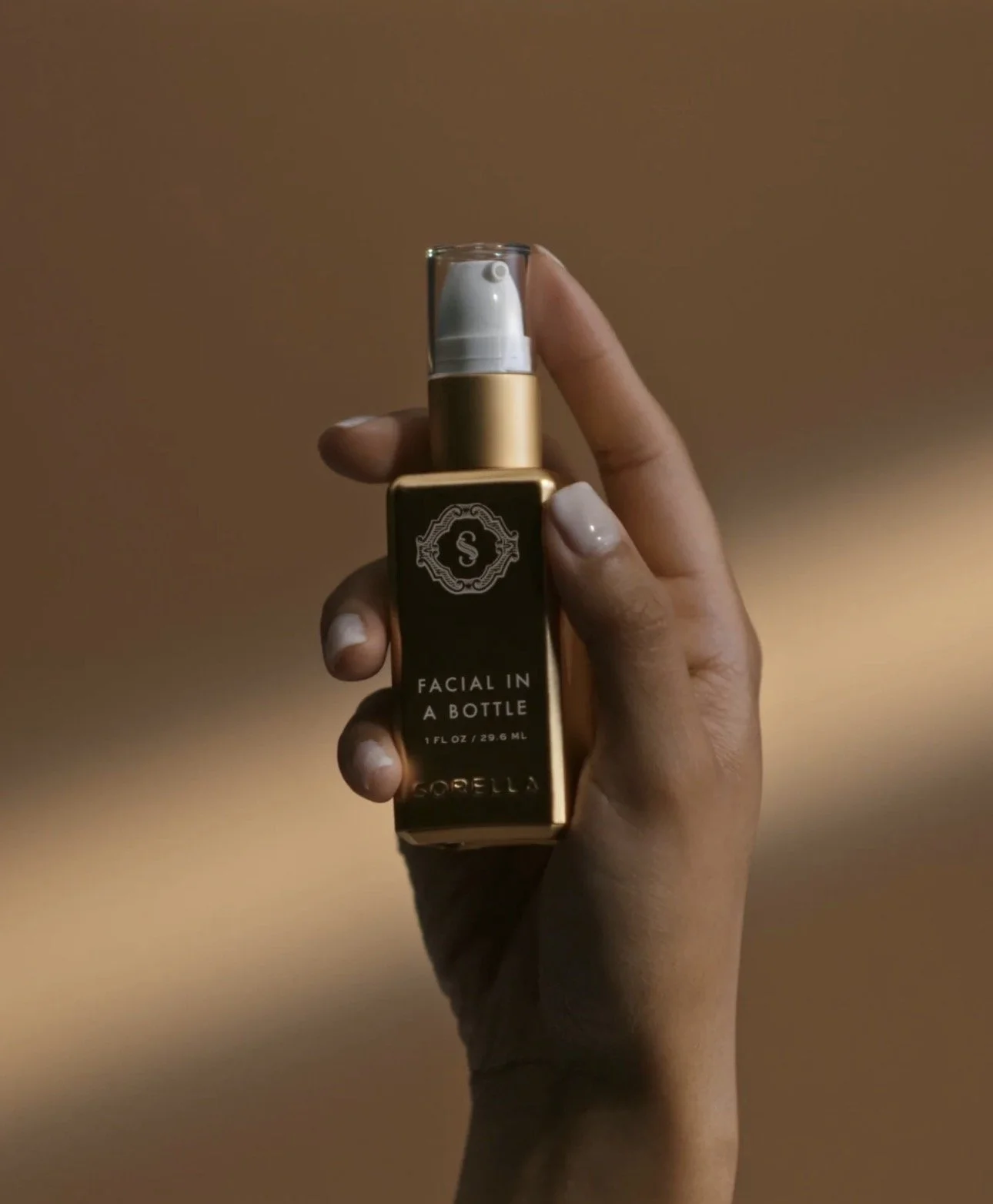 A bottle of Sorell Deep Clean facial cleanser submerged in a white bowl filled with foamy soap or bubbles.