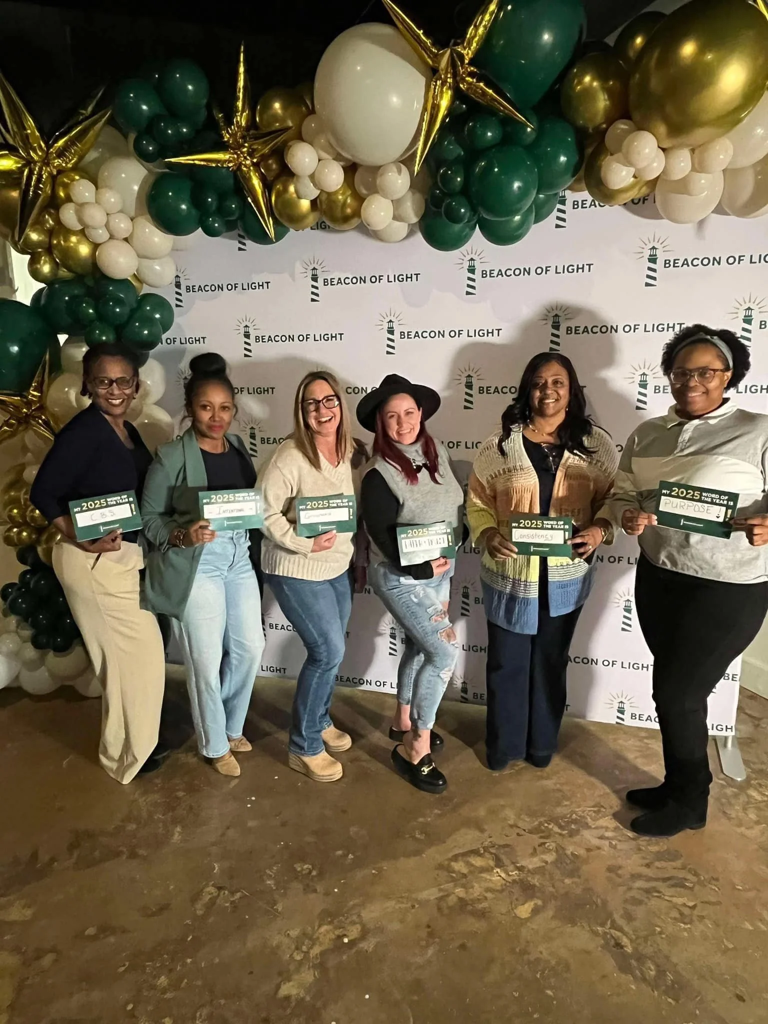 Group of six women standing in front of a 