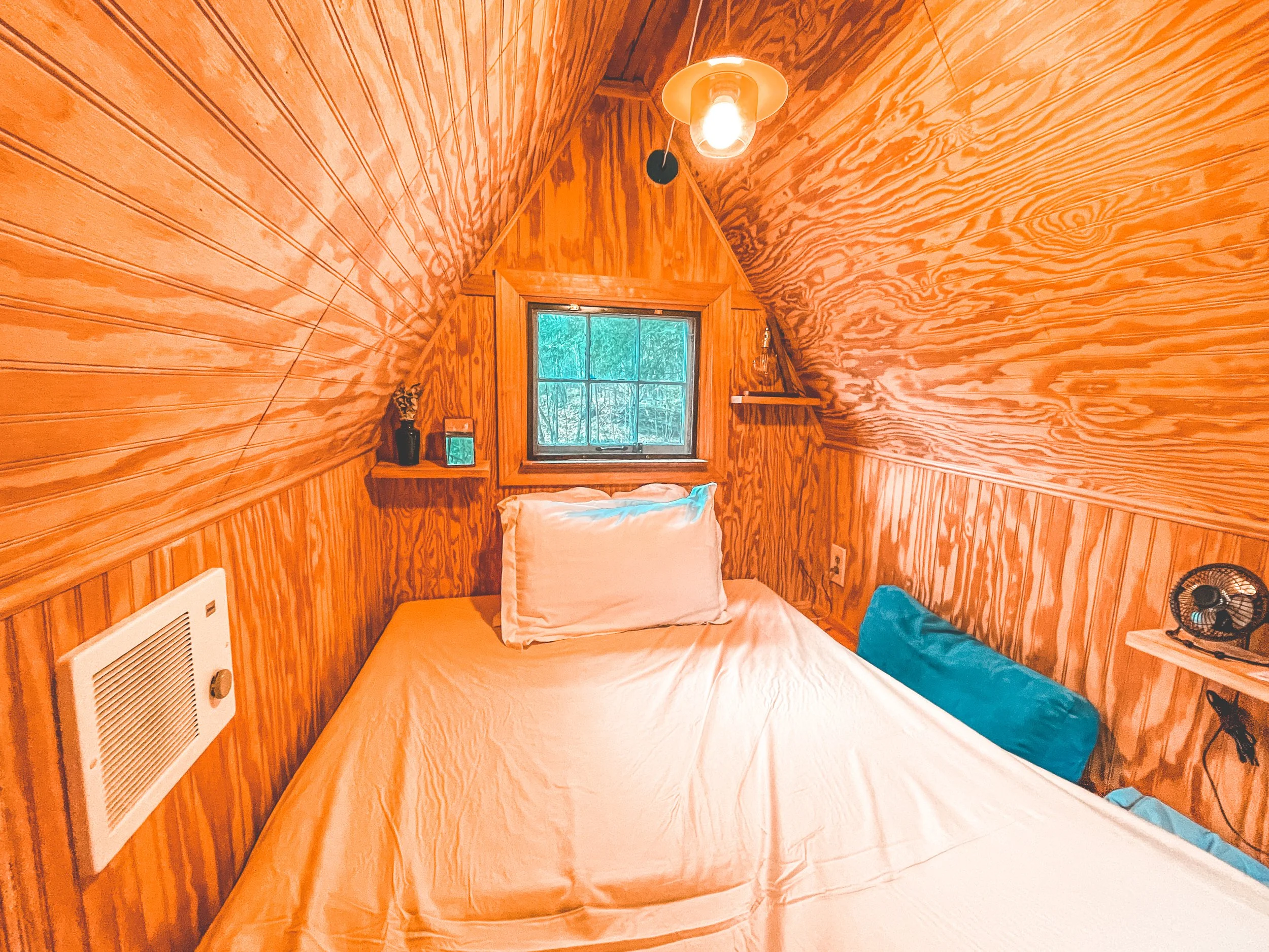 upstairs inside the tiny cabin, has electricity/heating/fridge