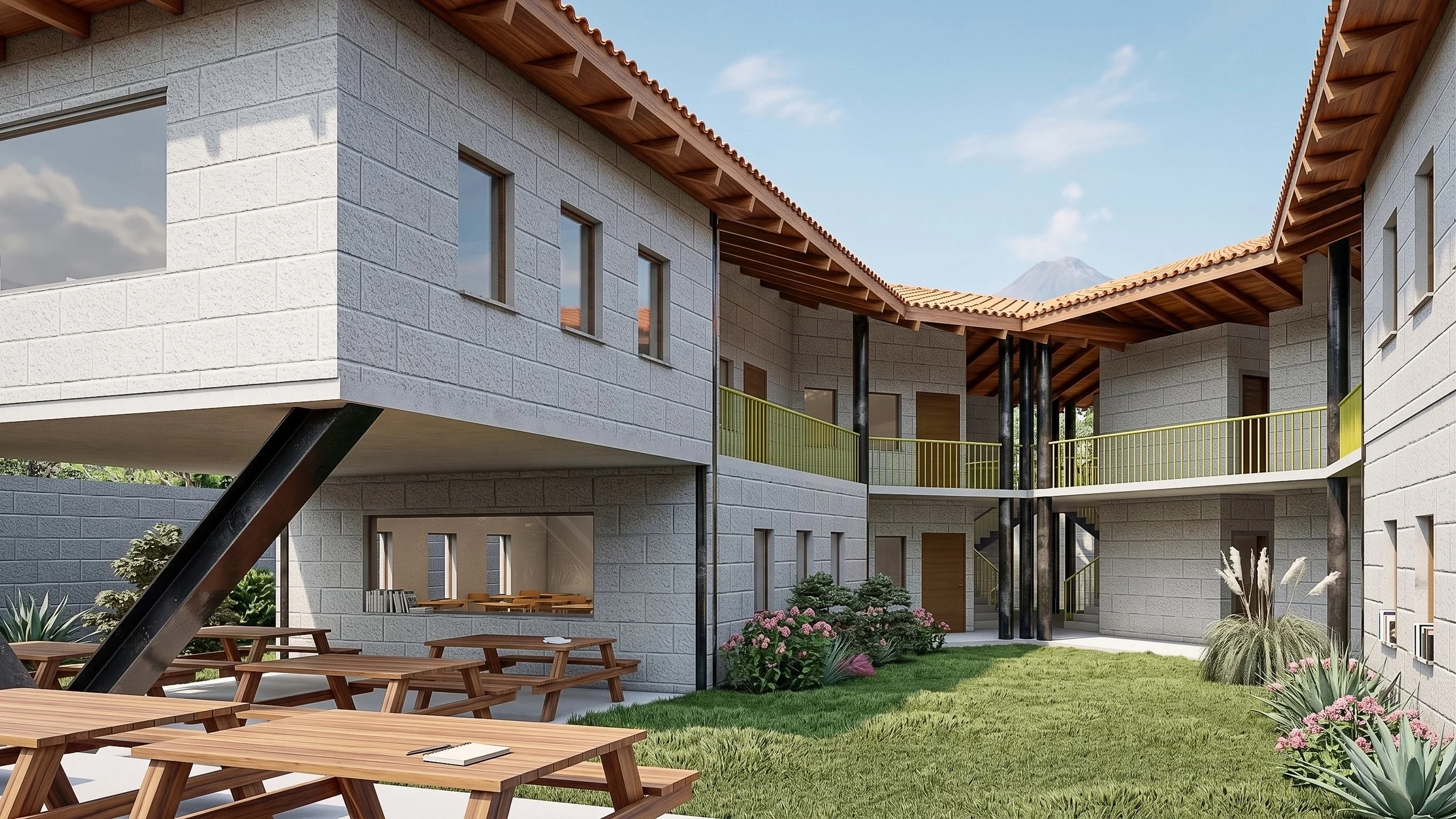 Edificio moderno en antigua de varias plantas con paredes de bloques de piedra y techos de tejas. Tiene balcón con barandal amarillo y áreas verdes con plantas, flores y mesas de madera en el patio. Diseñado por Atelier Oficina de Arquitectura